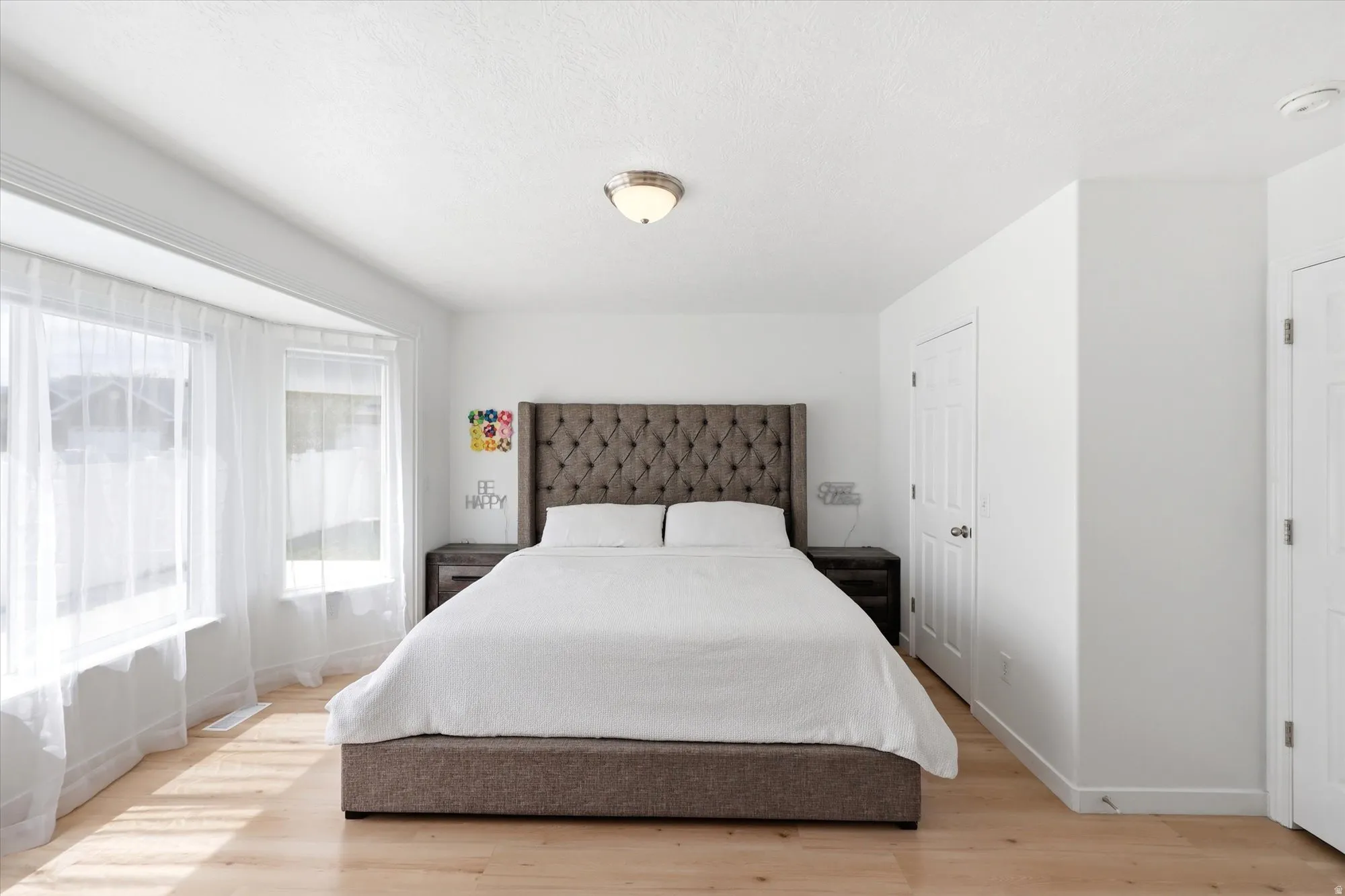 Bedroom featuring light wood-style flooring and baseboards
