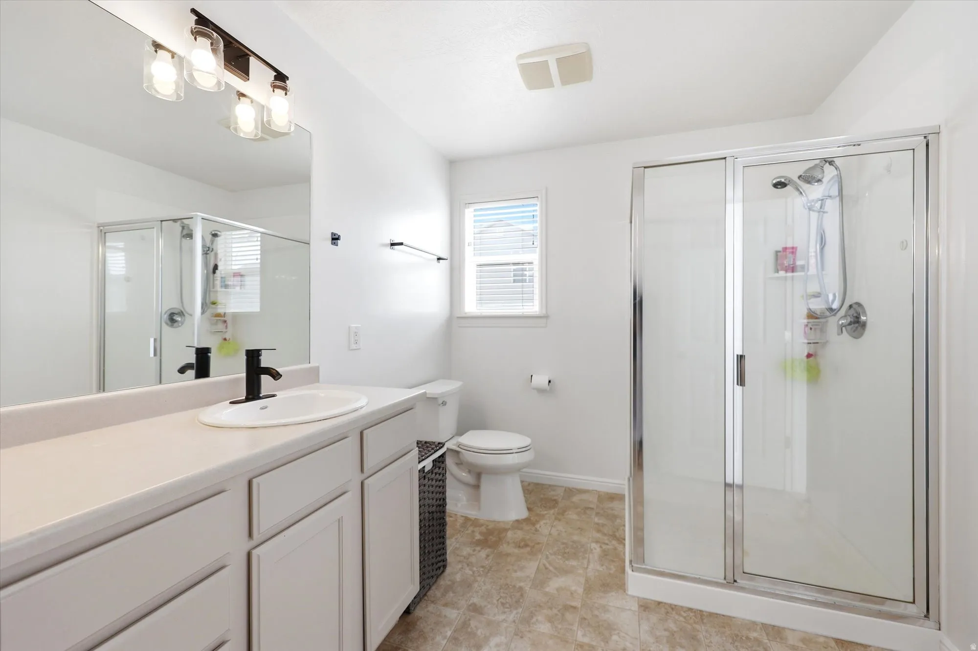 Full bath with vanity and a shower stall