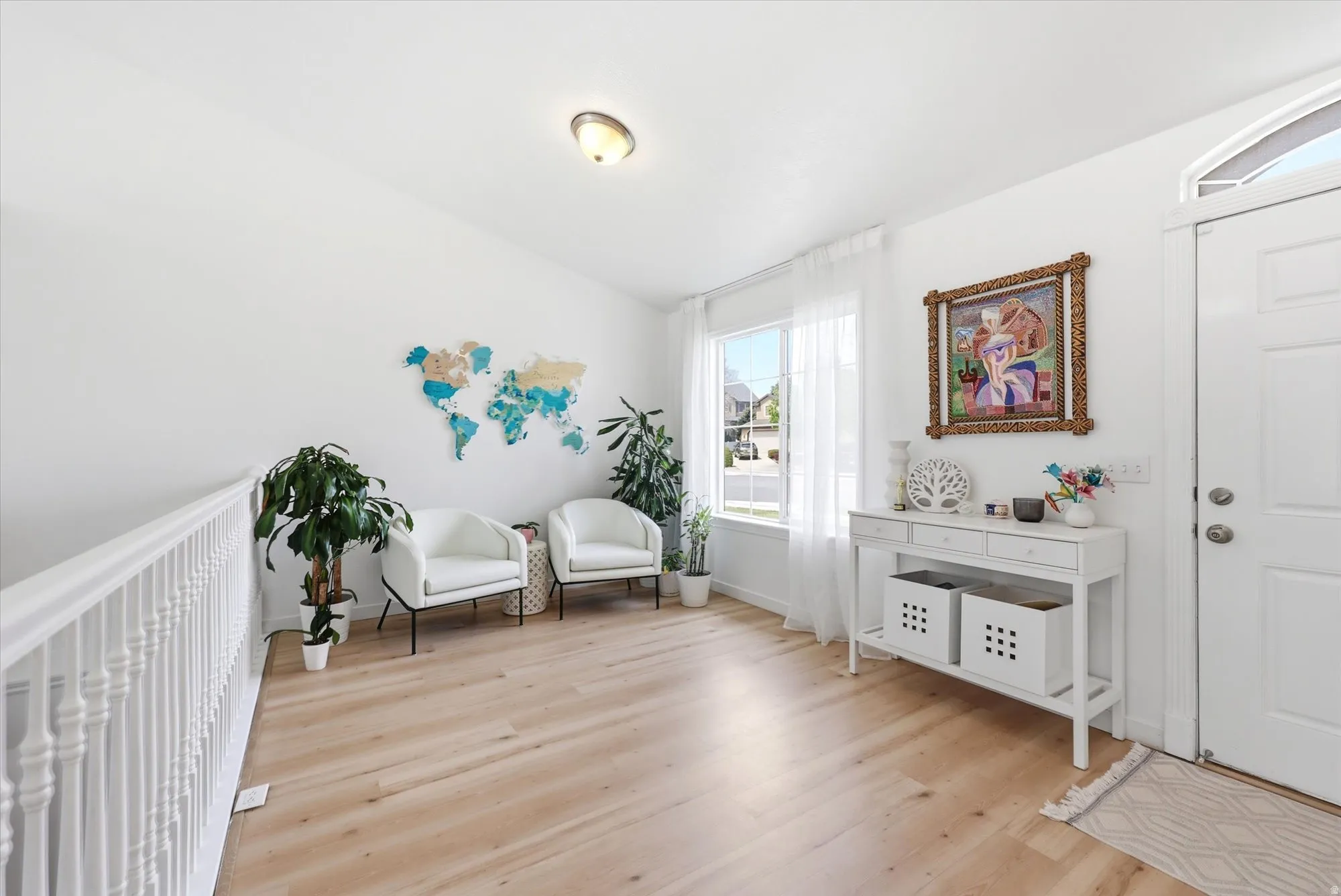 Sitting room featuring light wood finished floors and lofted ceiling