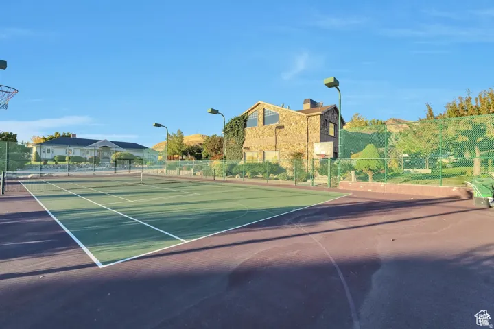 View of tennis court featuring community basketball court