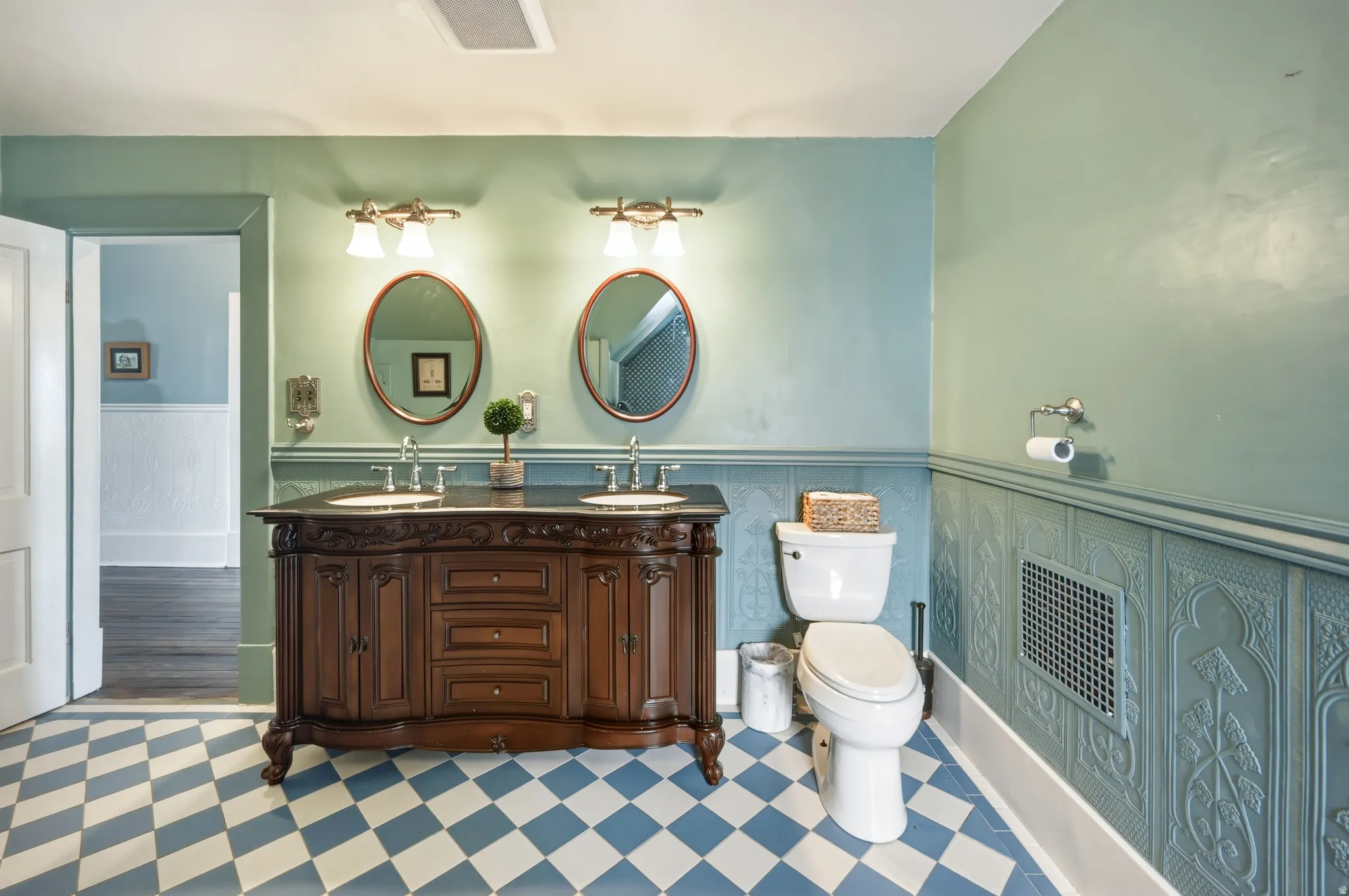 Full bathroom featuring Lincrusta imported from England, double vanity