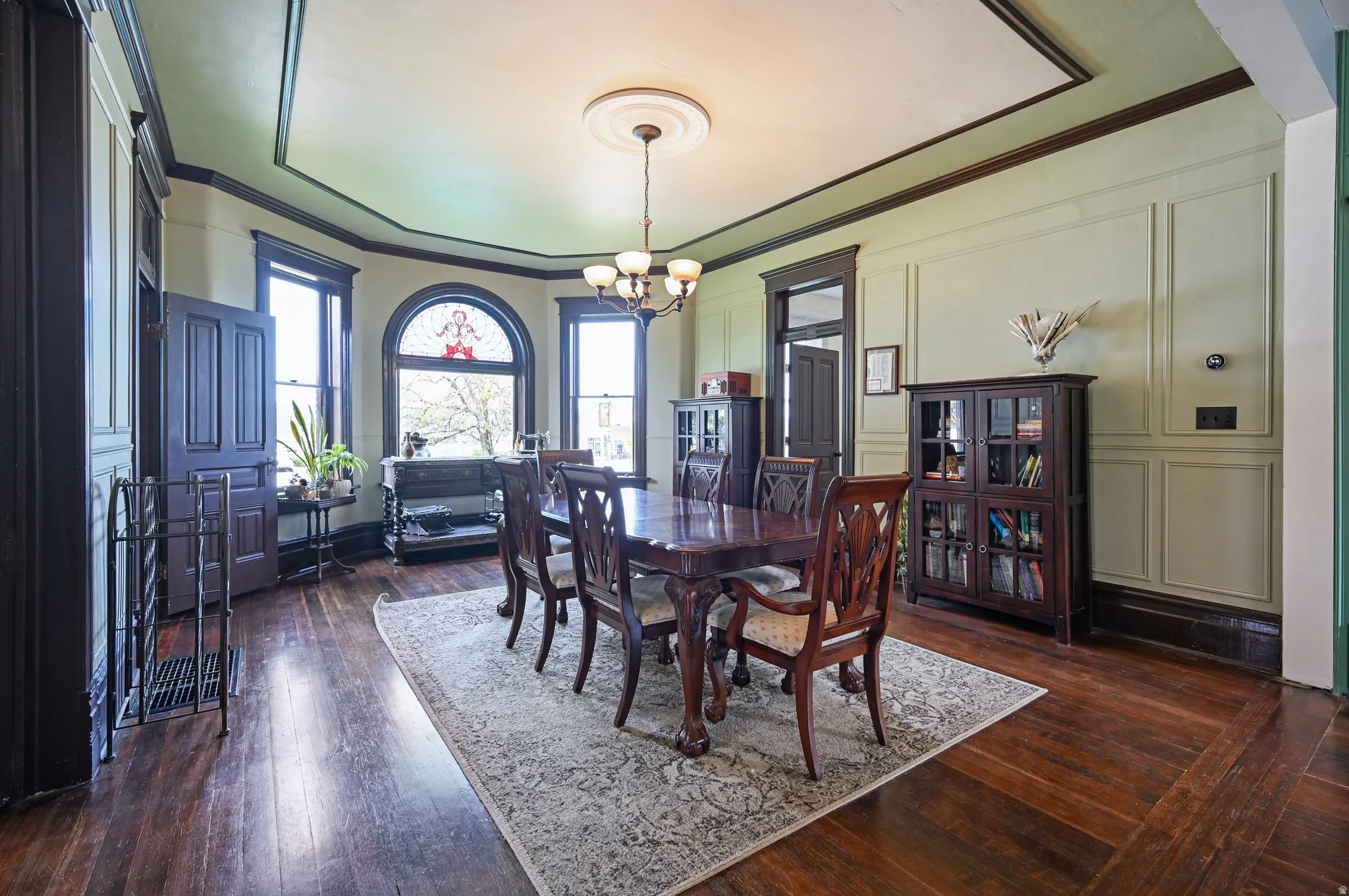 Dining space with chandelier, and ornamental molding