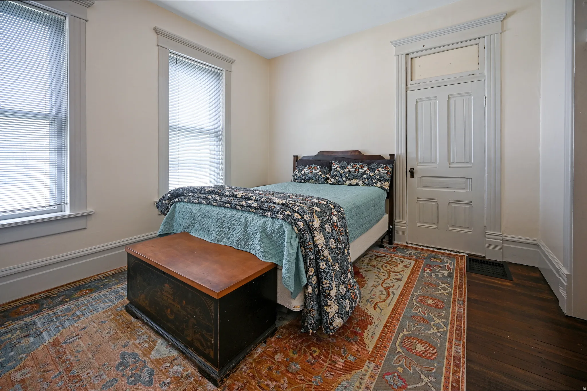 Main floor bedroom featuring walk-in closet & attached ensuite bath