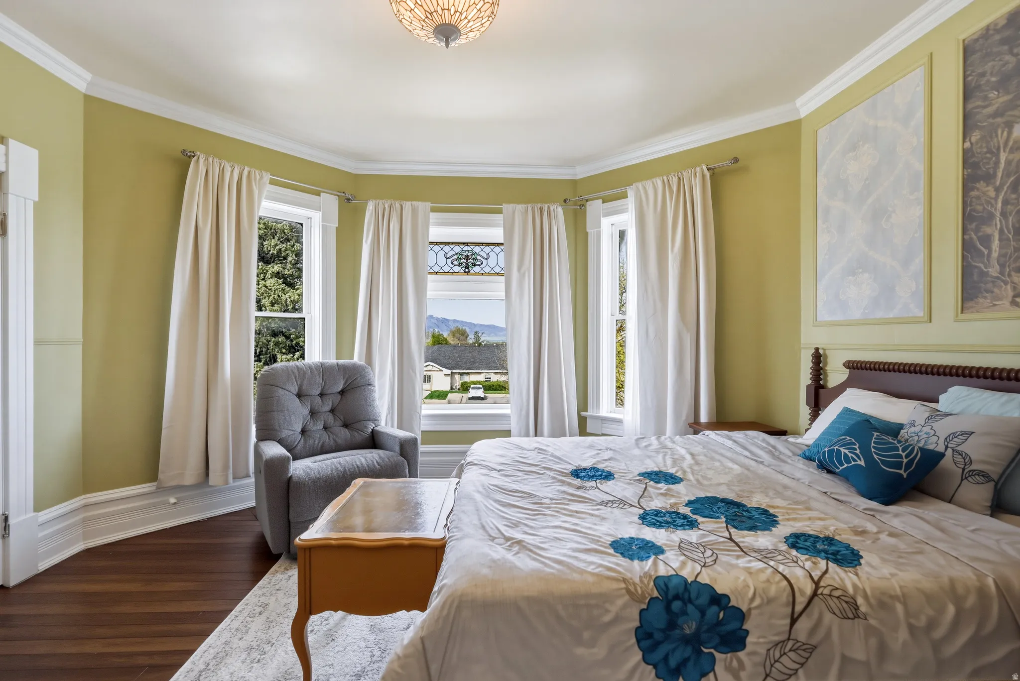Bedroom featuring bay window with stained glass detail