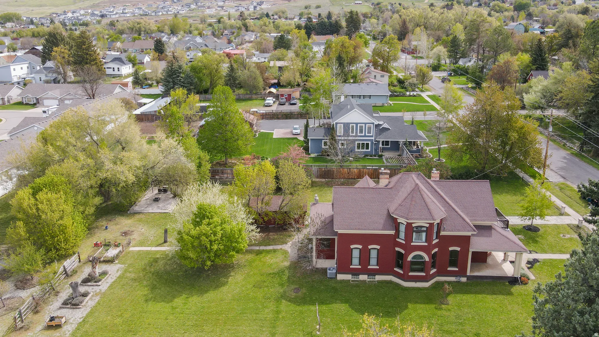 Aerial perspective of .77 acer yard, garden area & producing orchard