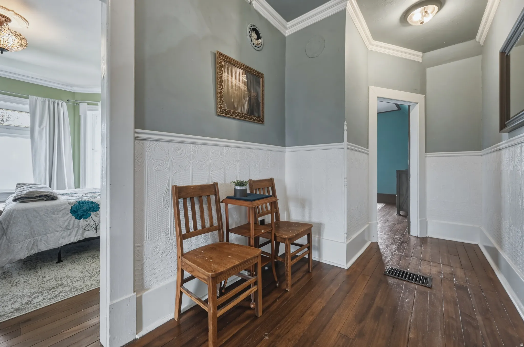 Hallway, ornamental molding, dark wood flooring
