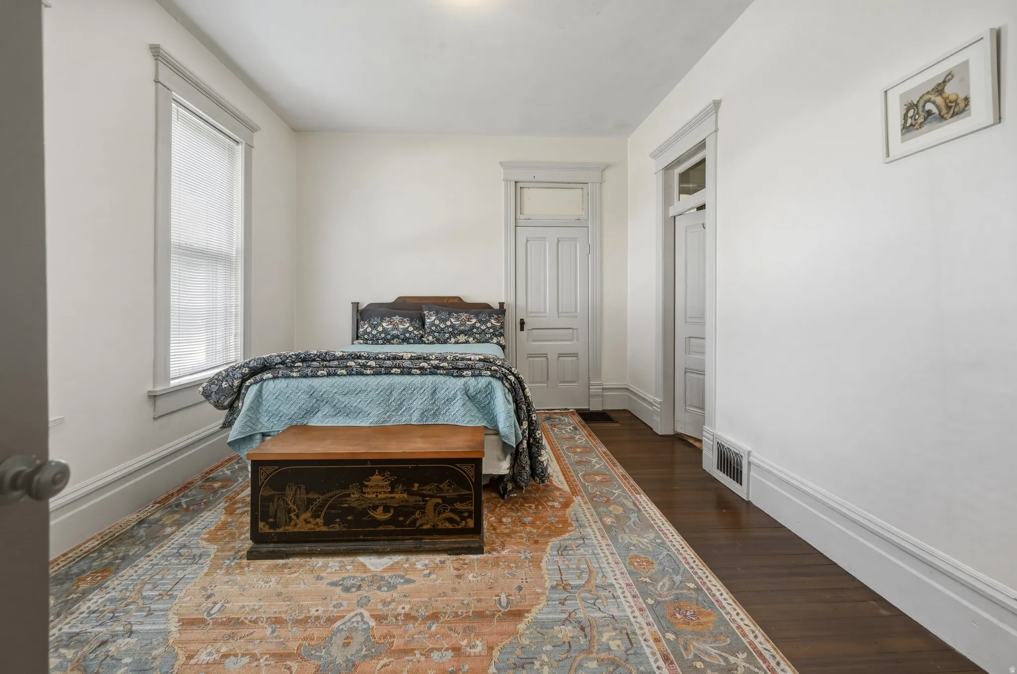 Main floor bedroom featuring walk-in closet & attached ensuite bath