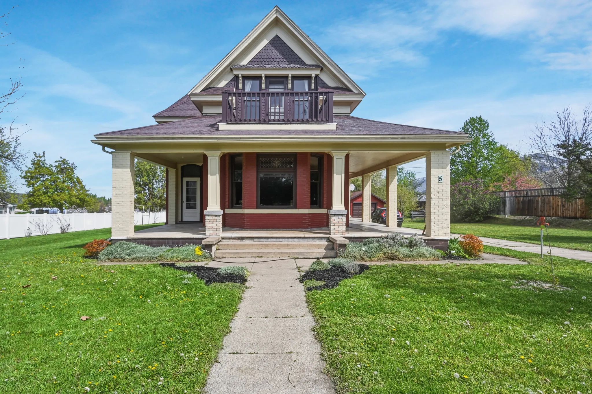 Victorian house featuring a porch &brick siding
