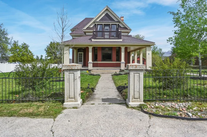 Victorian house with a fenced front yard & porch