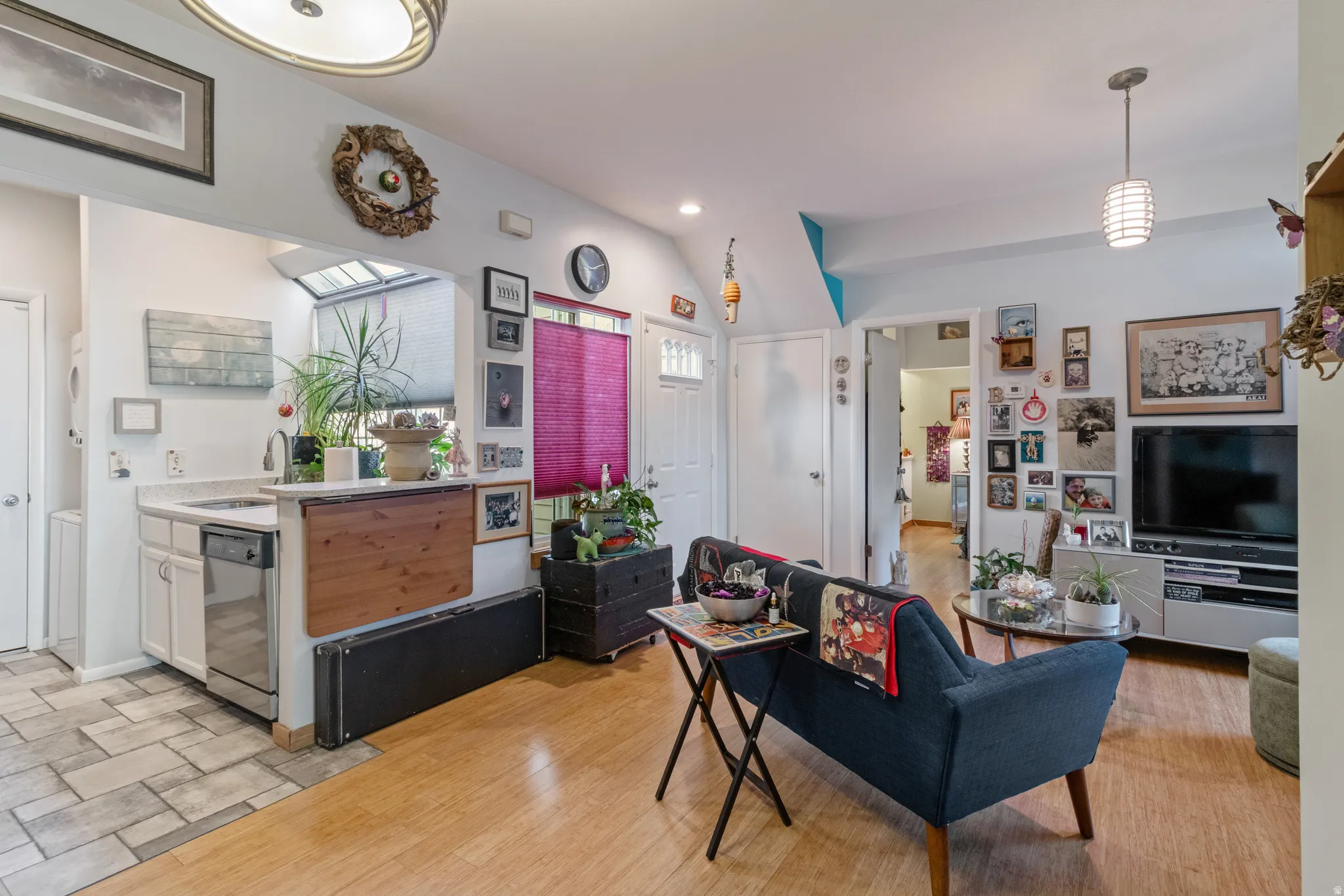 Living area featuring vaulted ceiling and recessed lighting