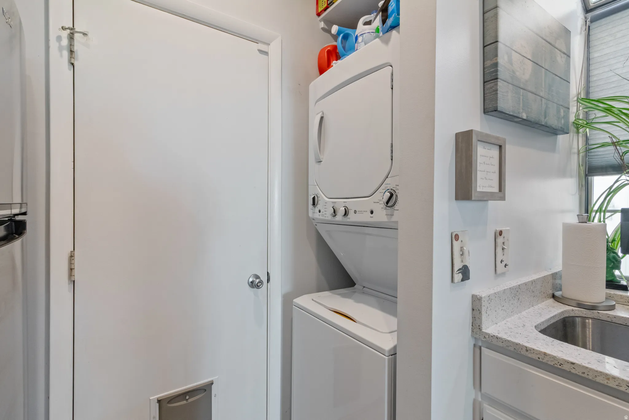 Laundry area with stacked washer / drying machine