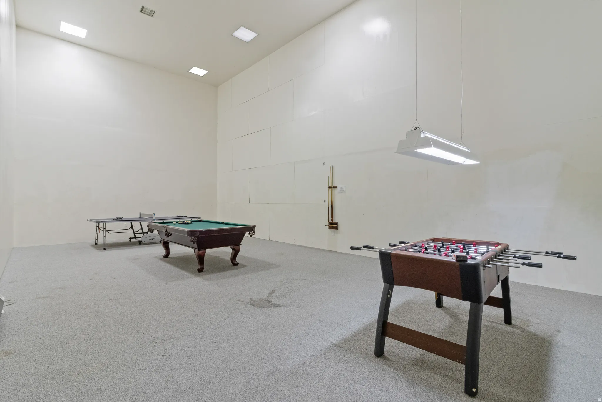 Club house game & Playroom with a high ceiling, billiards table, and carpet floors