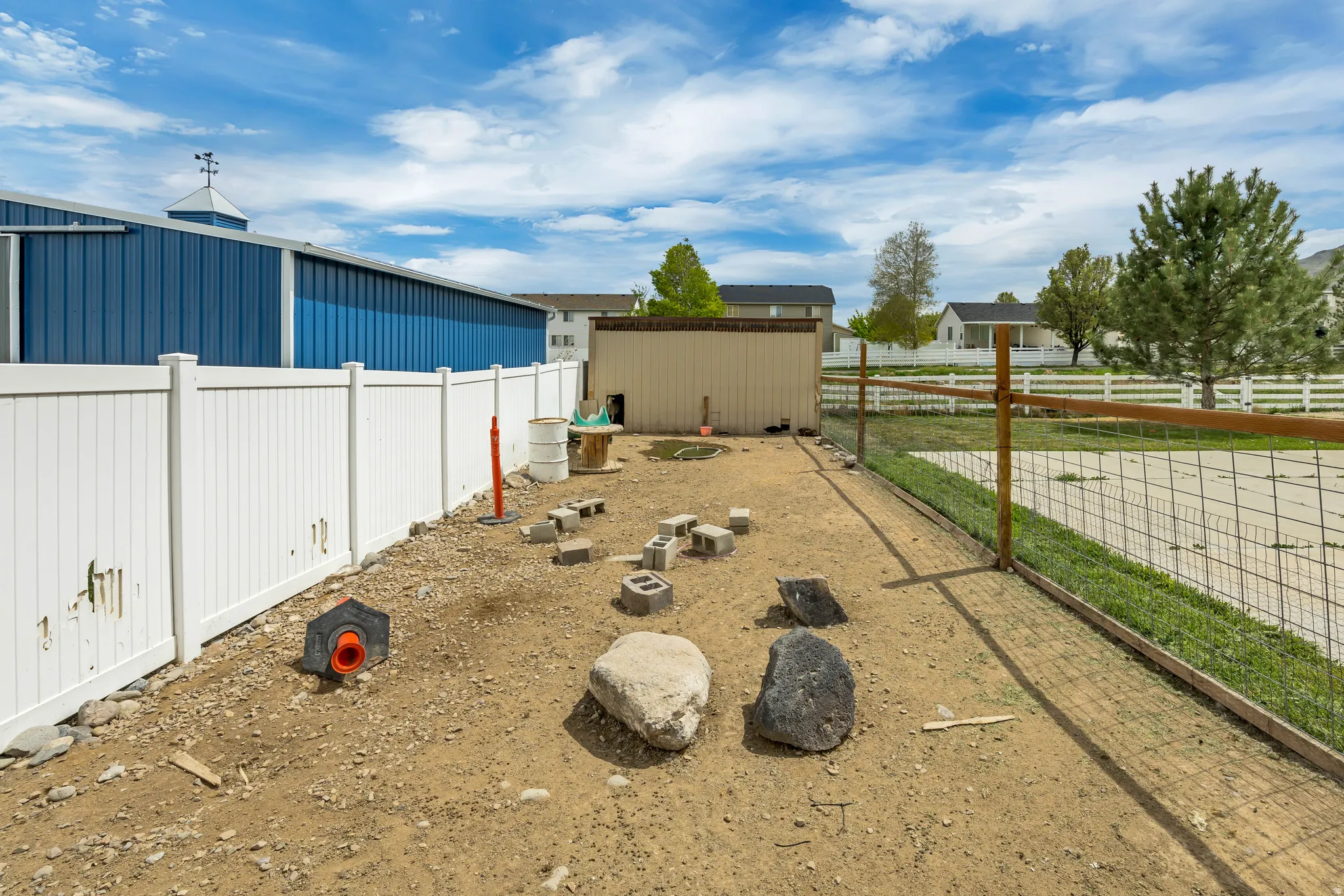 Fenced backyard featuring a storage shed