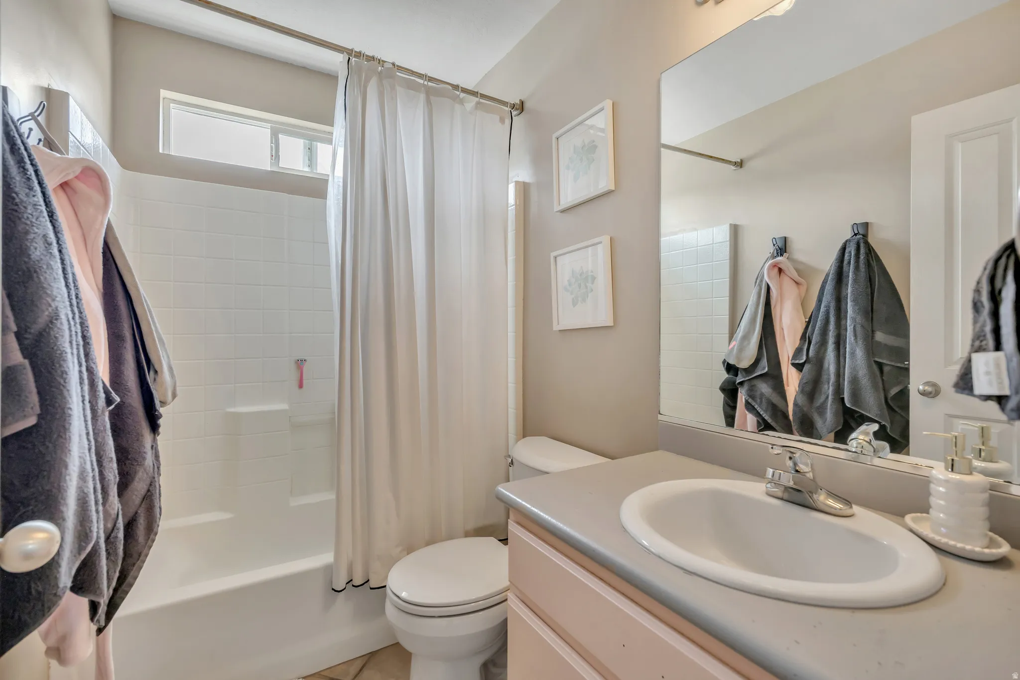 Bathroom featuring vanity and shower / tub combo