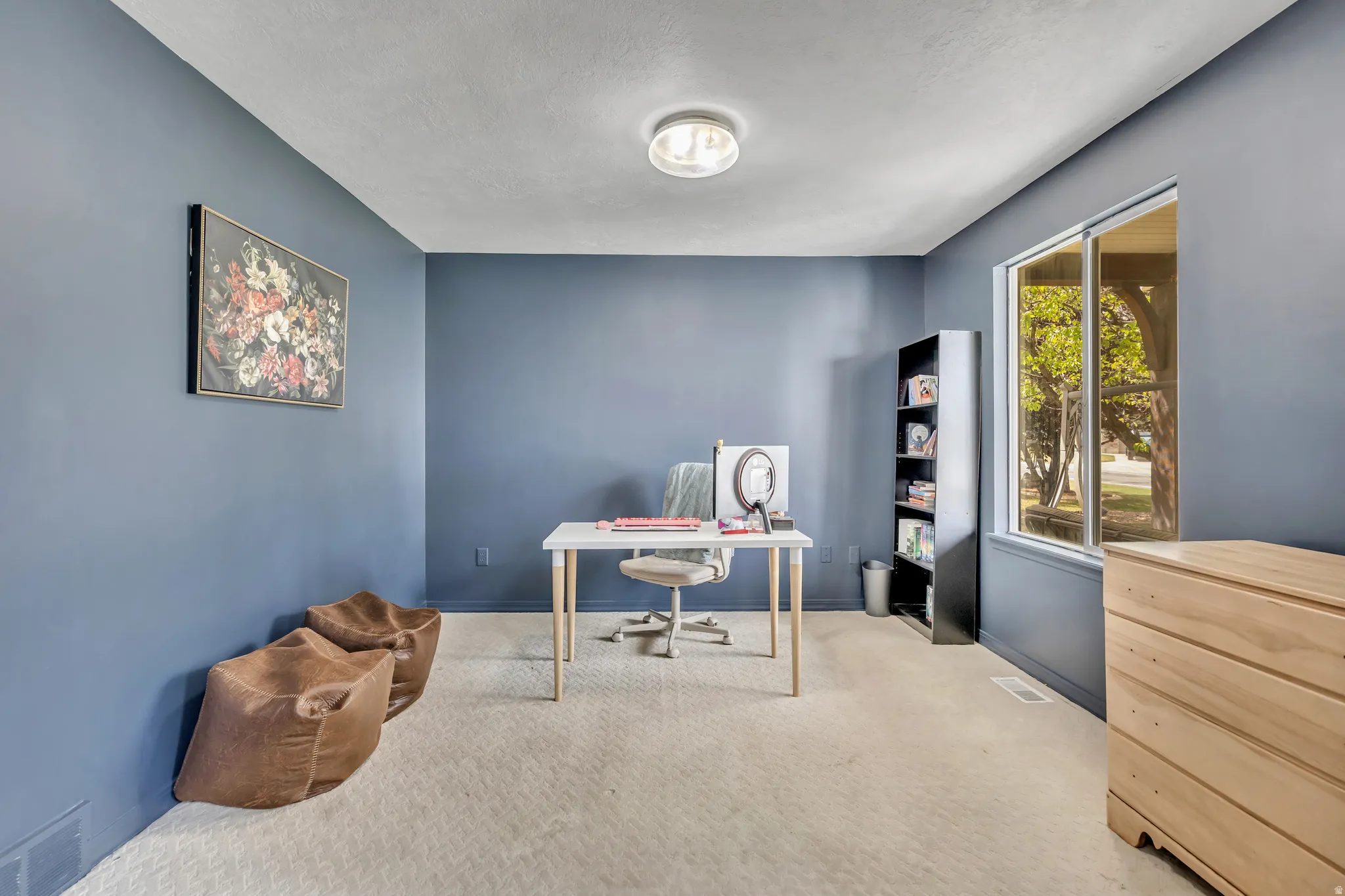 Office area with light carpet and a textured ceiling