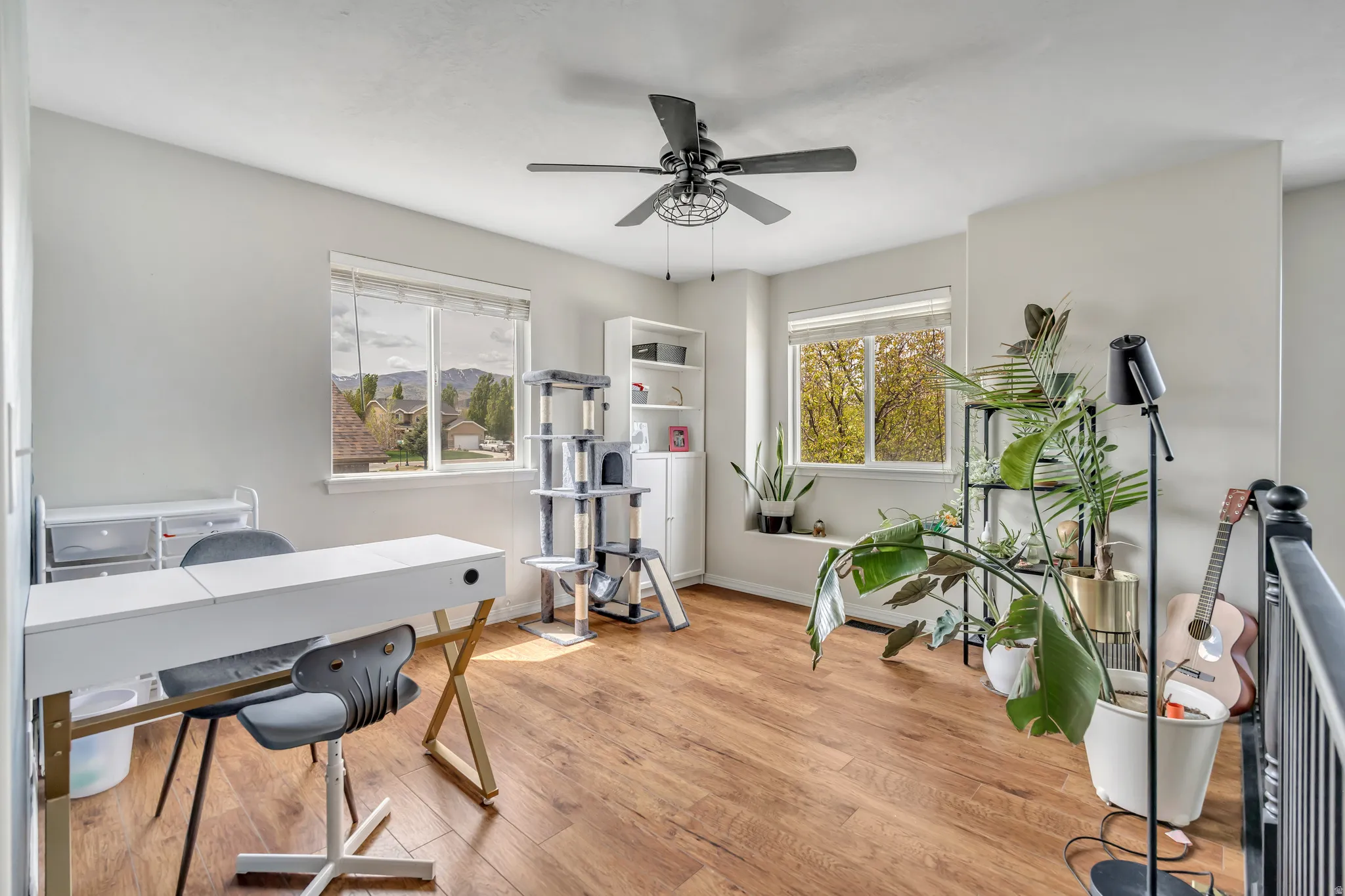 Office area with wood finished floors and a ceiling fan