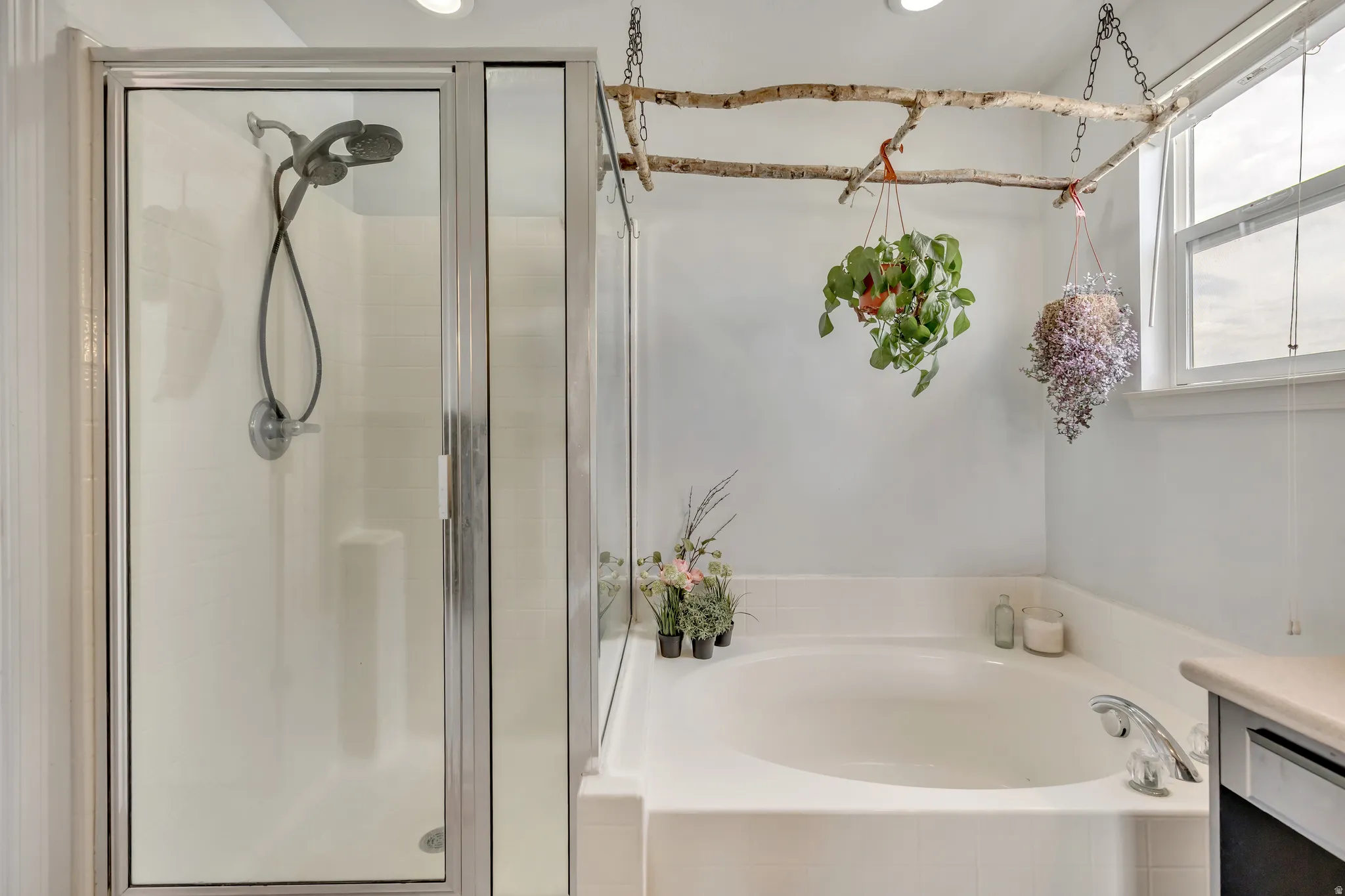 Bathroom featuring vanity, a bath, and a shower stall