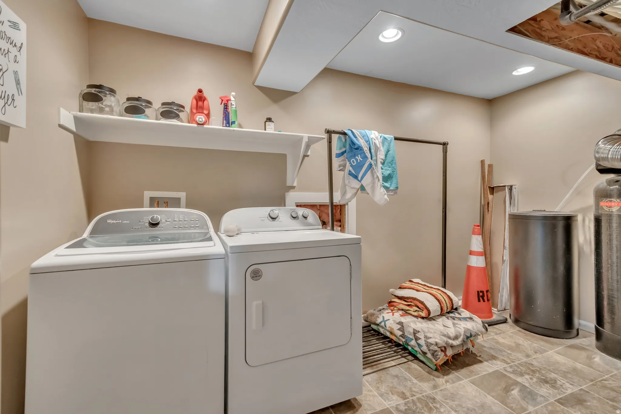 Laundry room featuring washing machine and clothes dryer, recessed lighting, and light stone finish floors