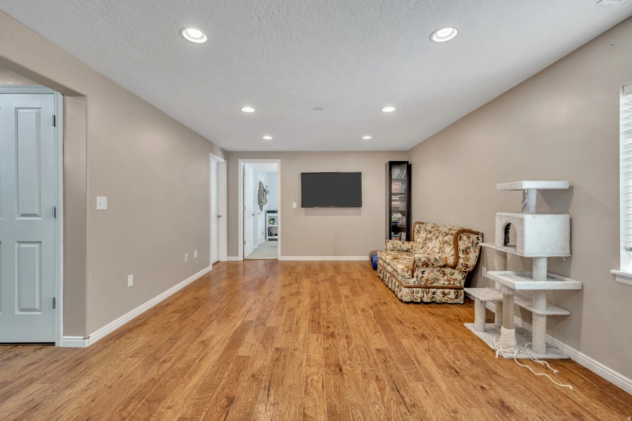 Unfurnished room with recessed lighting, light wood-style floors, and a textured ceiling