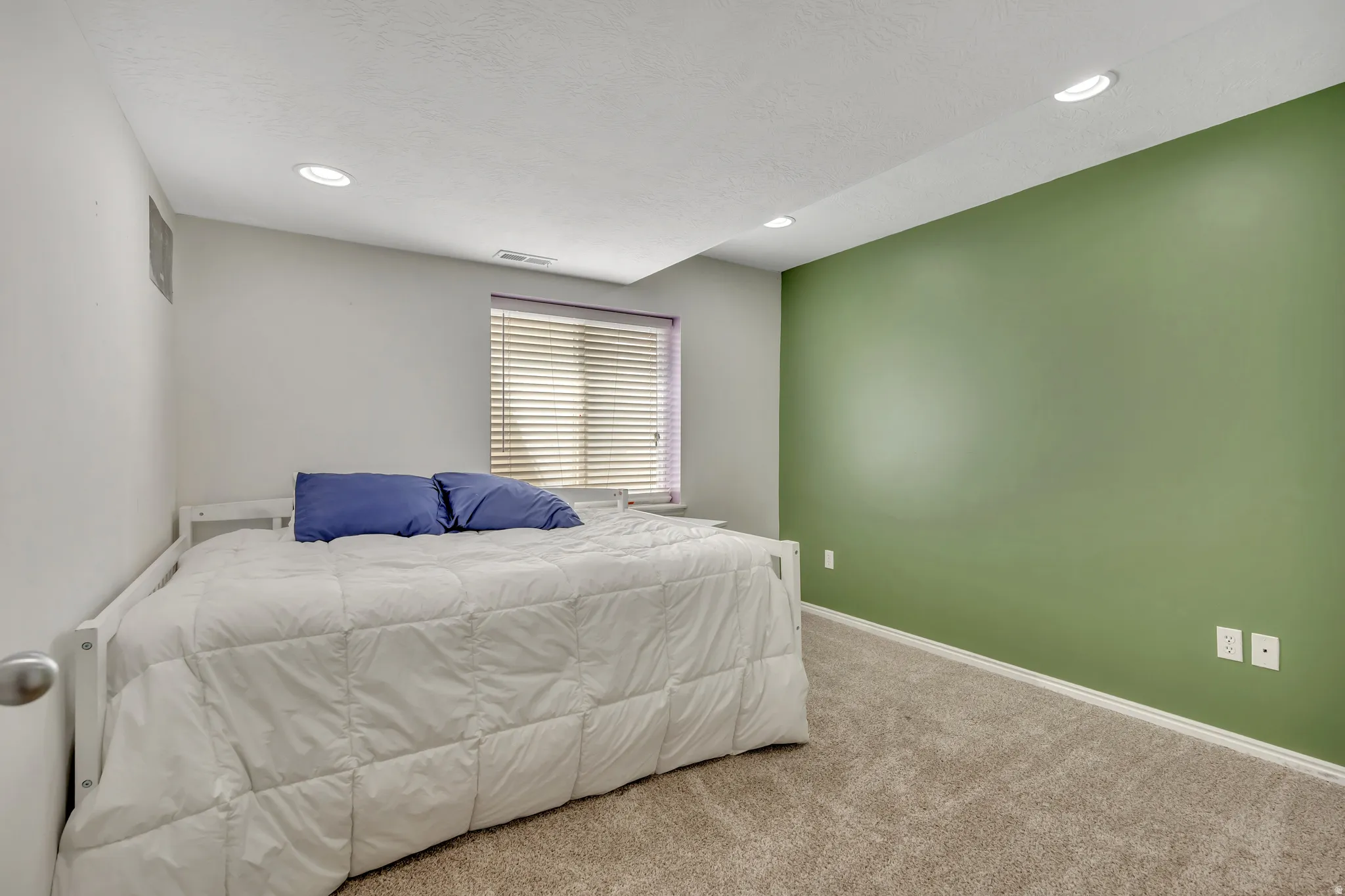 Bedroom with carpet floors and recessed lighting