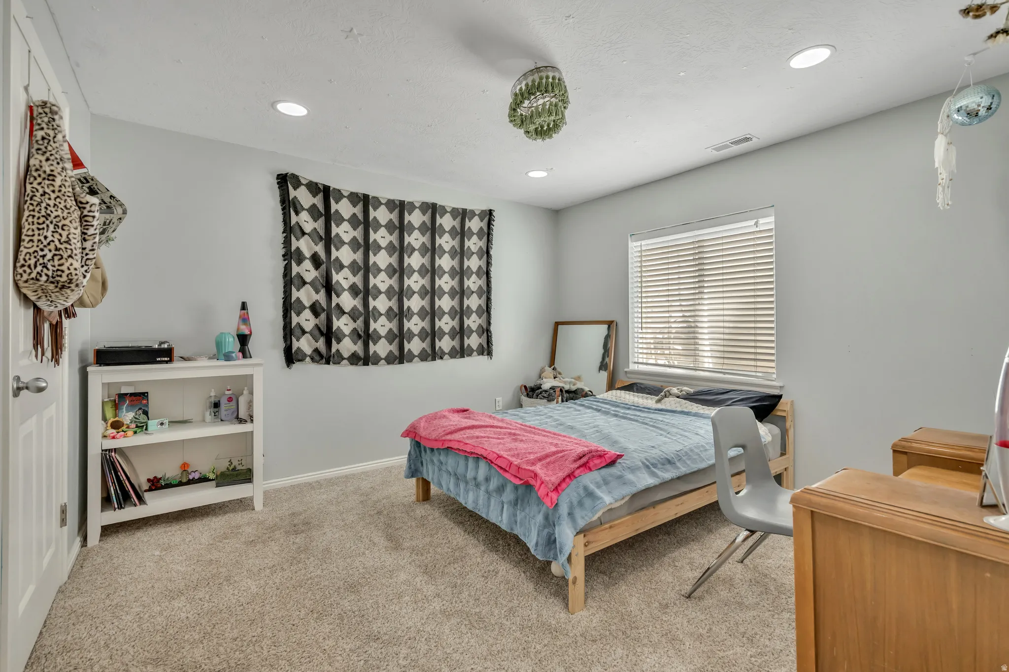 Bedroom featuring light carpet and recessed lighting