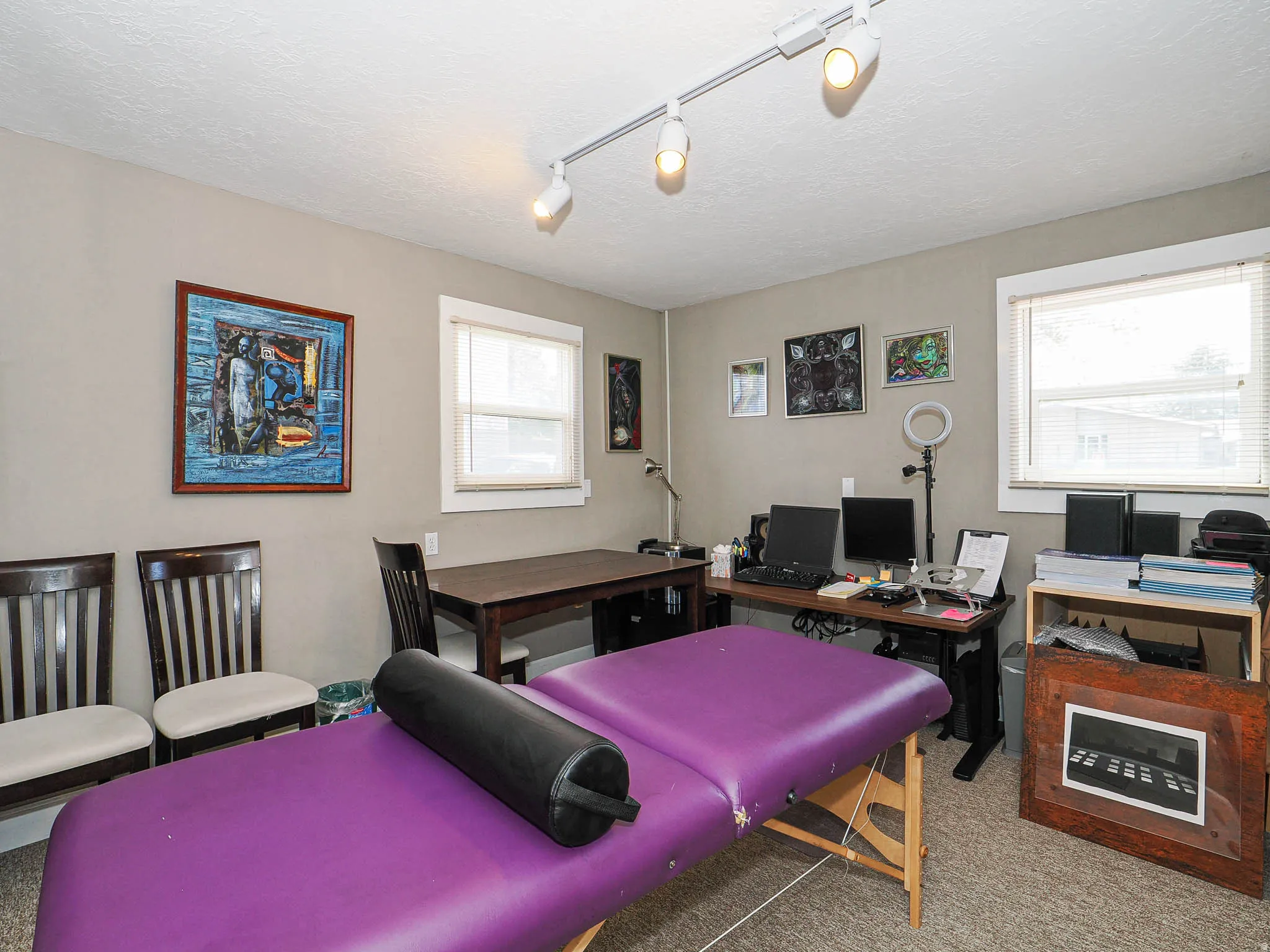Office featuring light colored carpet, rail lighting, and a textured ceiling