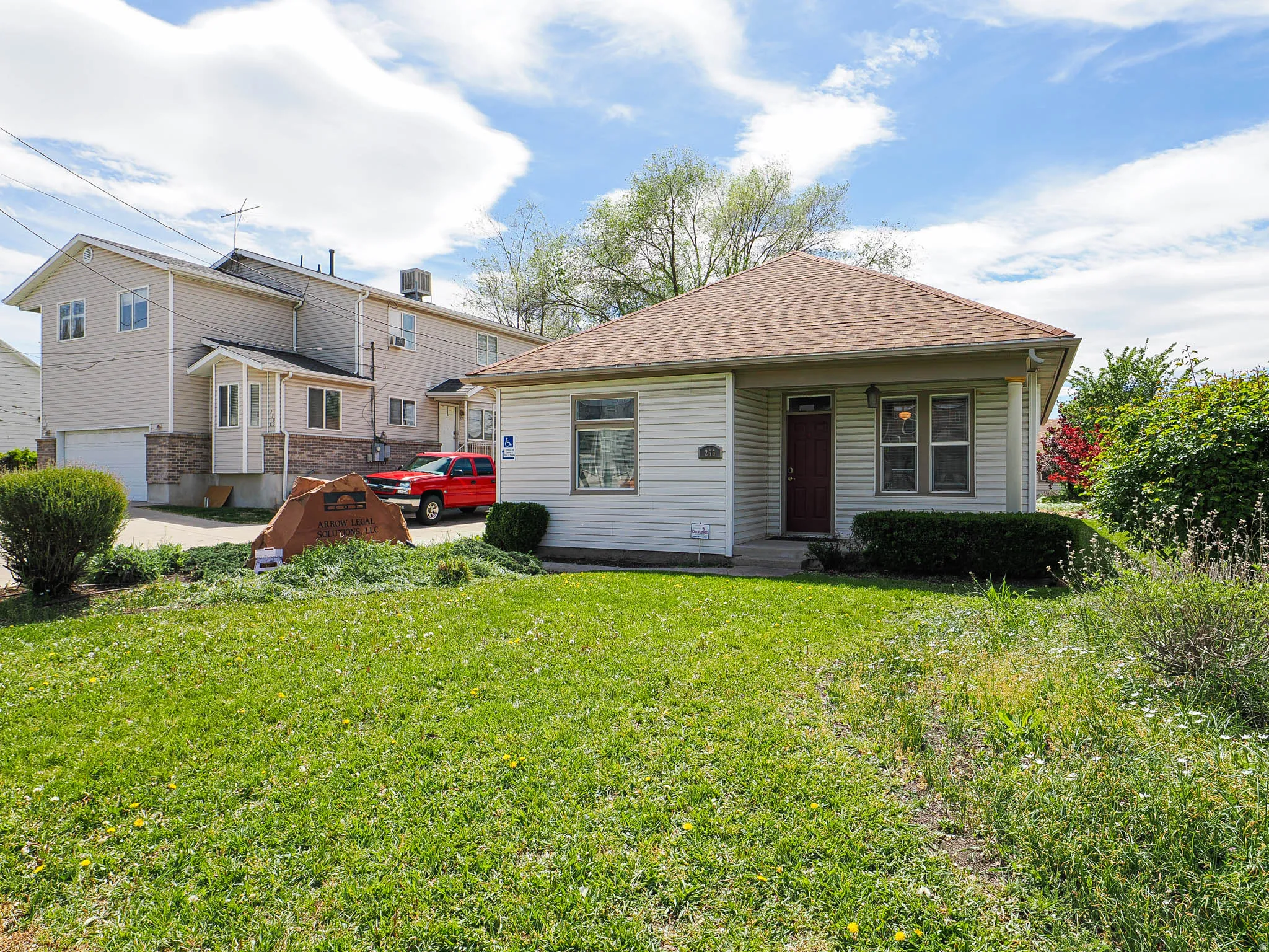 View of front of property featuring roof with shingles and a front yard