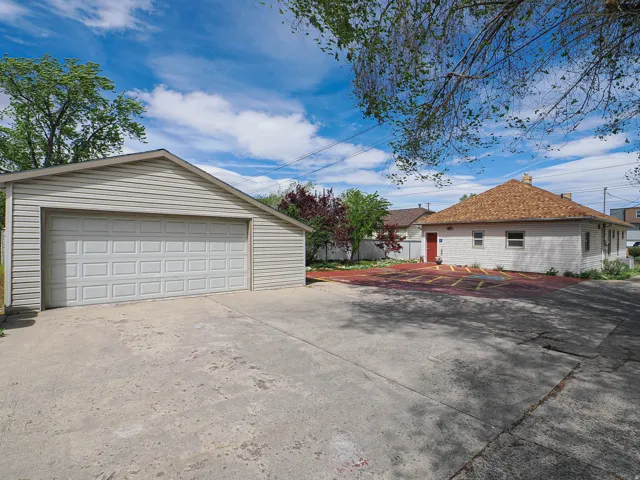 View of side of property with a garage and an outbuilding