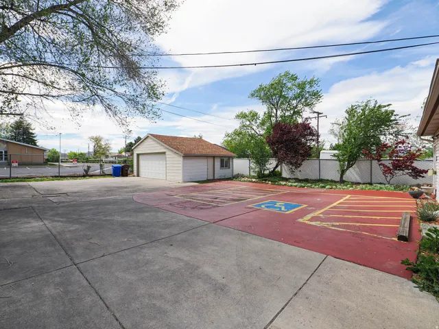 View of front of home with an outdoor structure and a garage