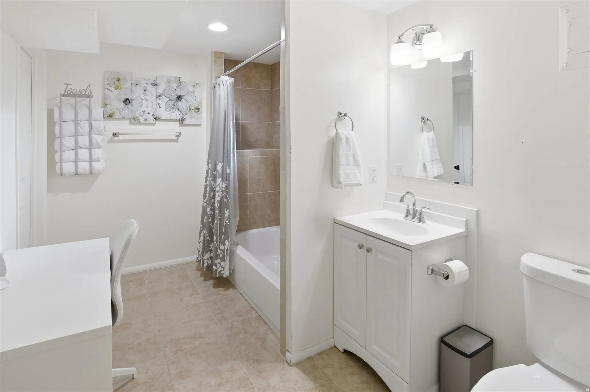 Bathroom featuring vanity, shower / tub combo with curtain, recessed lighting, and light tile patterned flooring