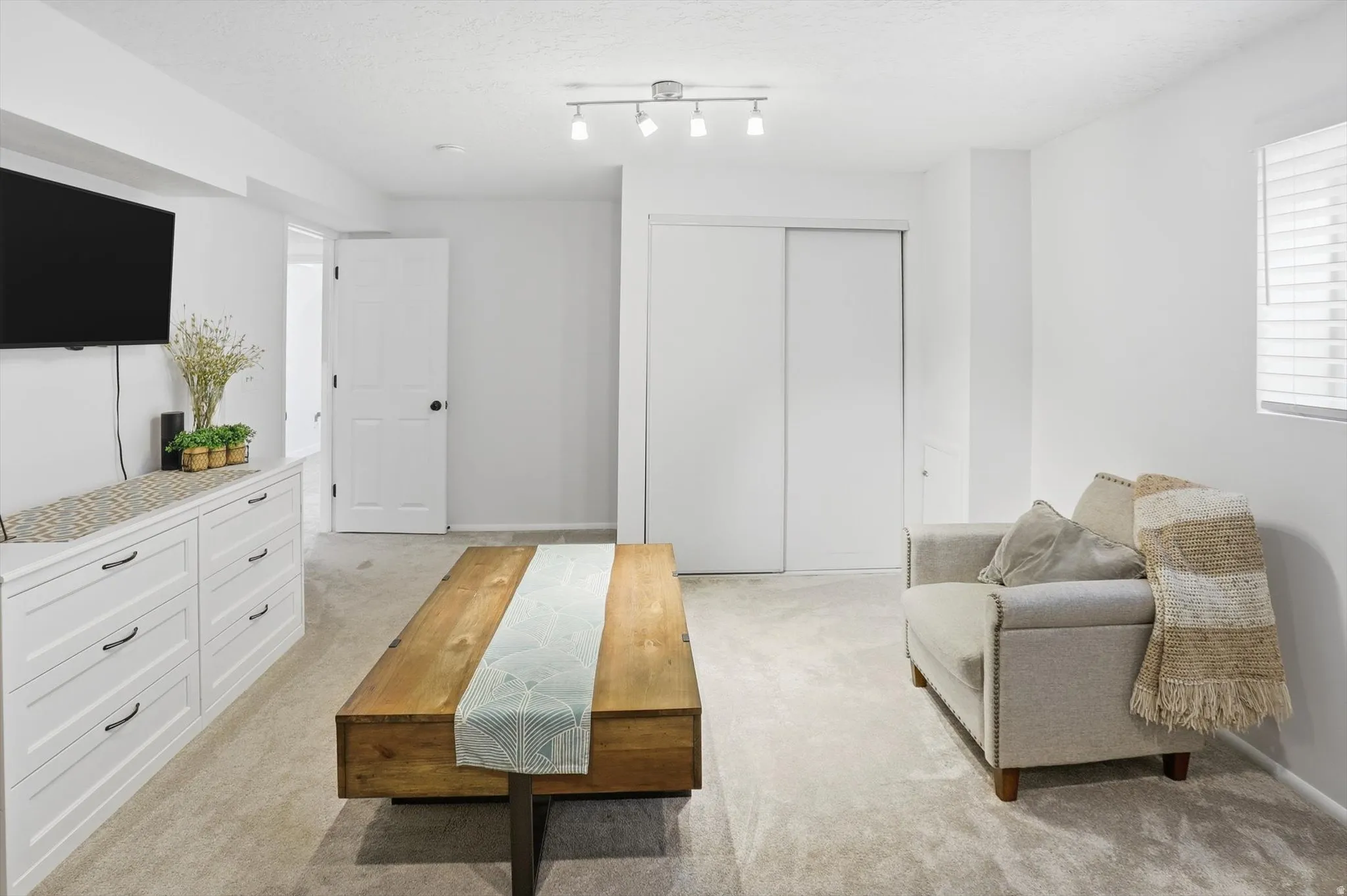6th Bedroom or Living/Family room with light carpet and a textured ceiling