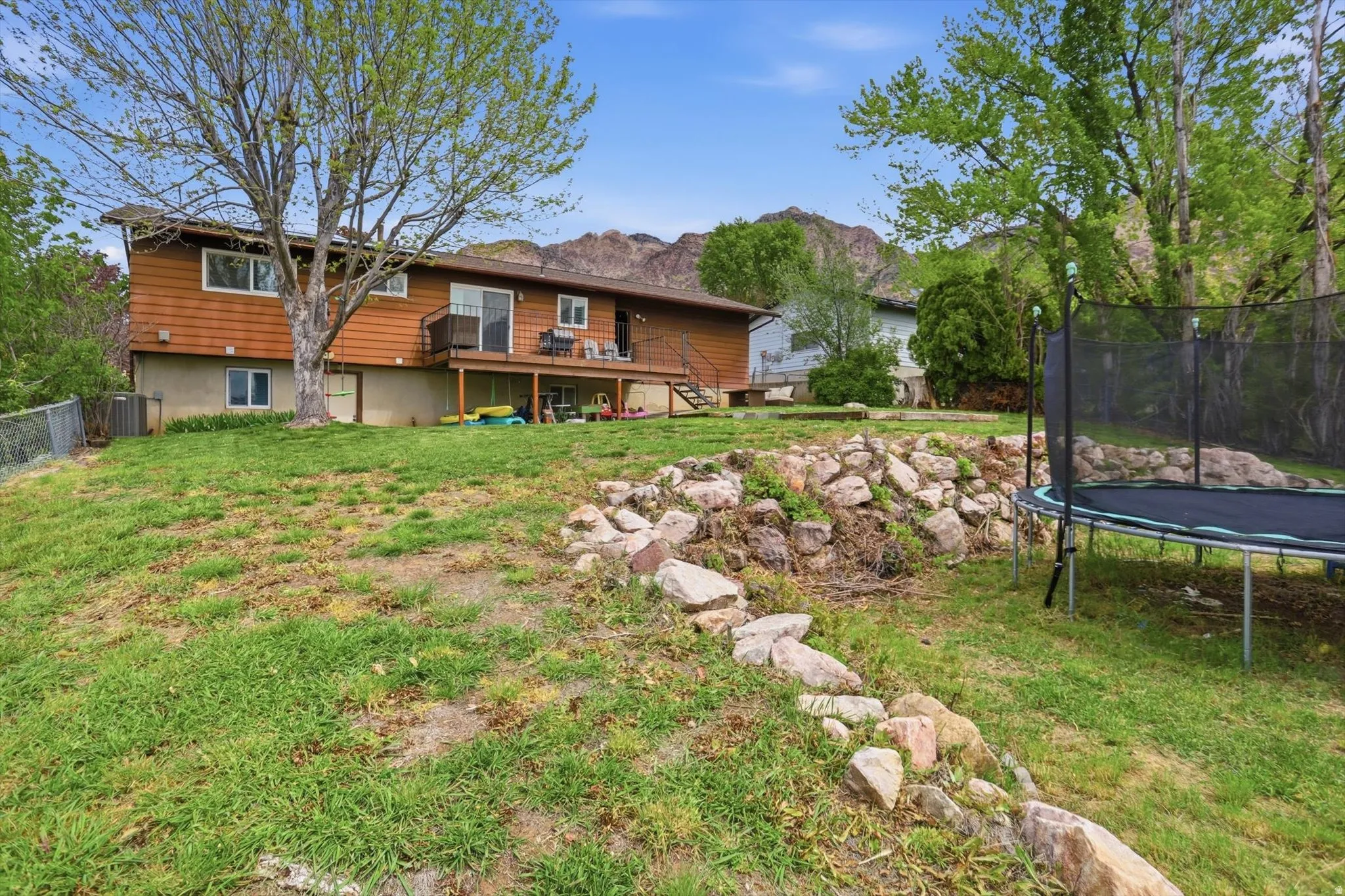 View of yard featuring a trampoline and a mountain view