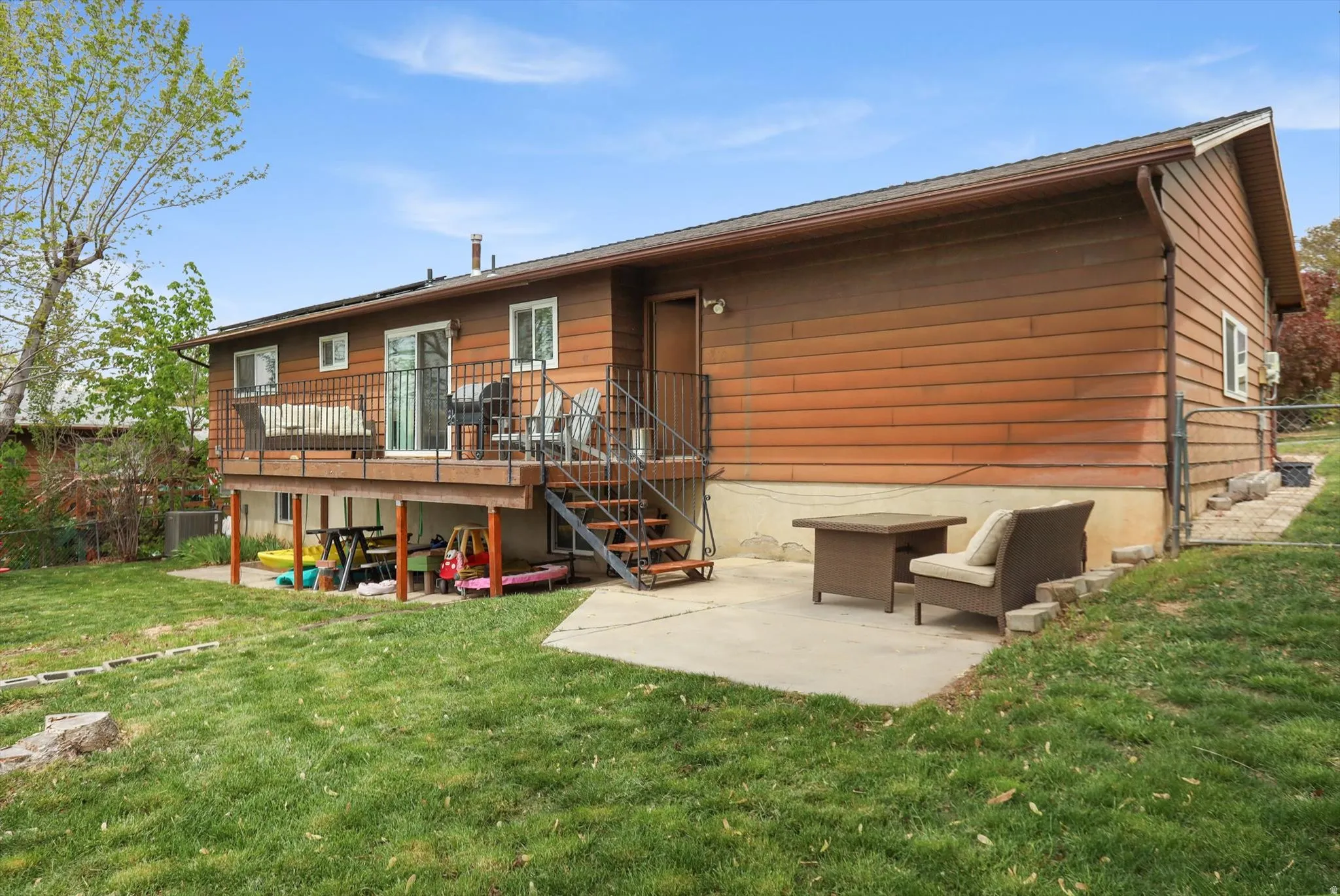 Rear view of house with a patio and a wooden deck