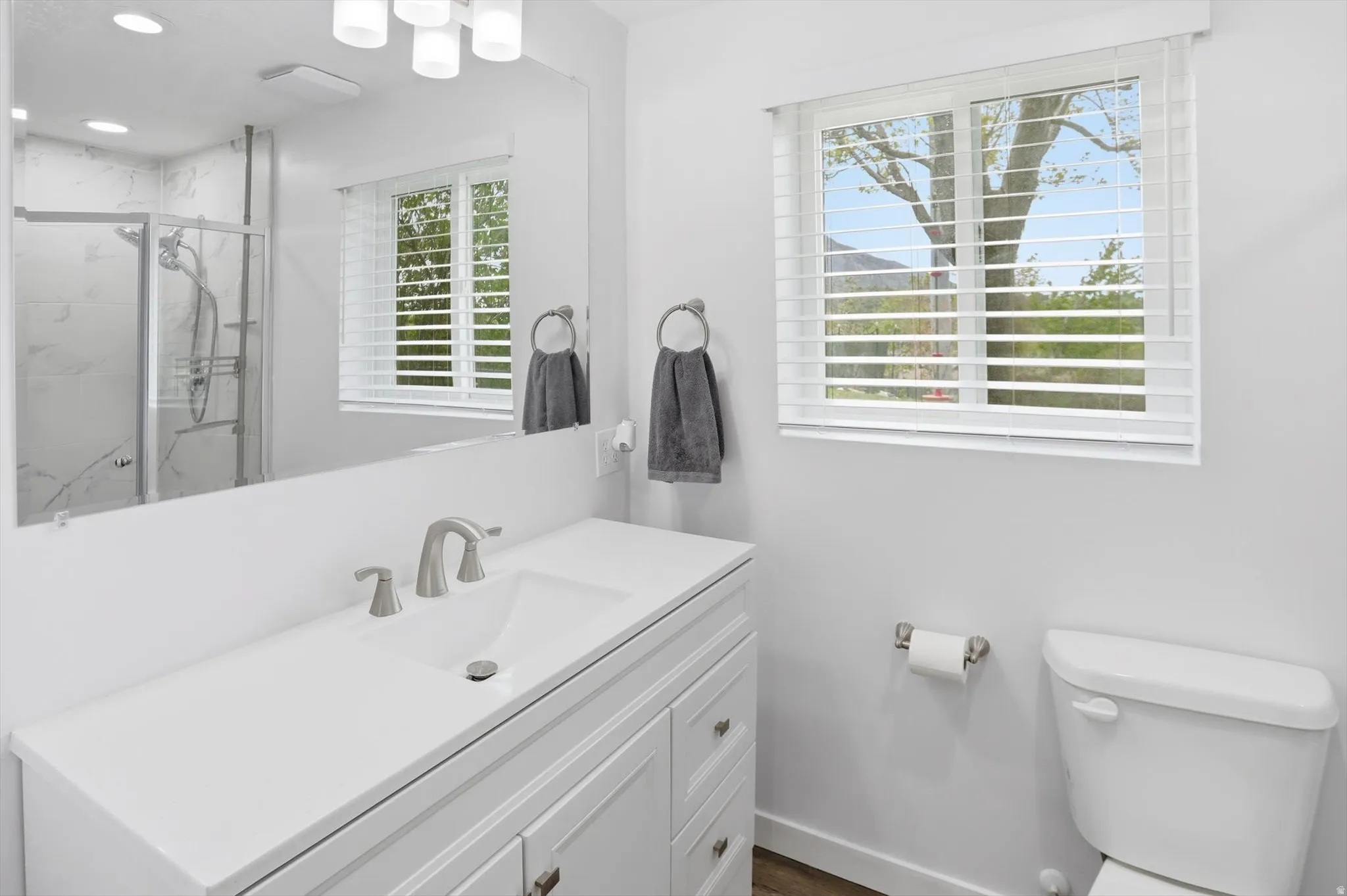 Full bathroom with vanity and a marble finish shower