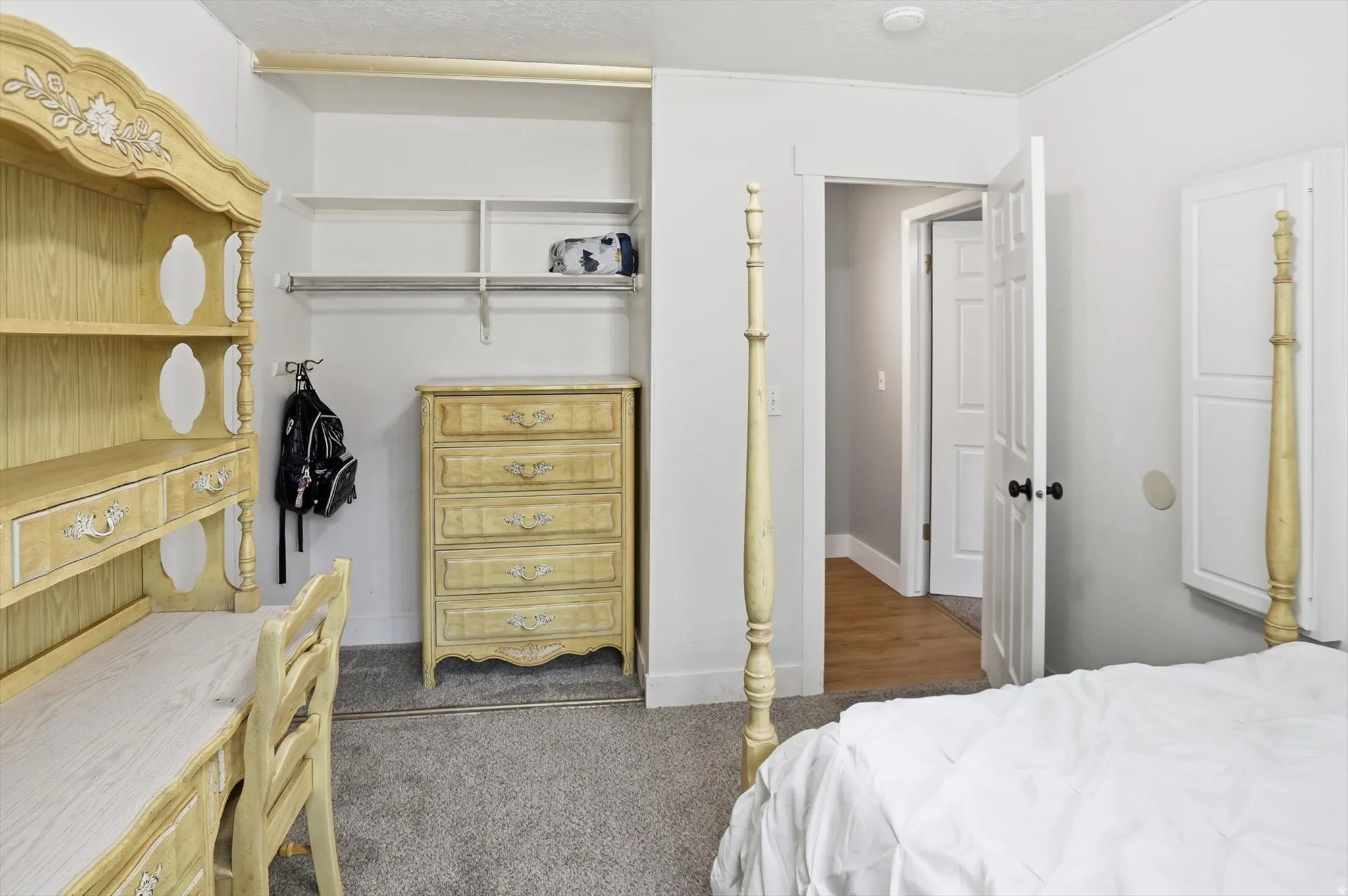 Bedroom with dark colored carpet and a textured ceiling