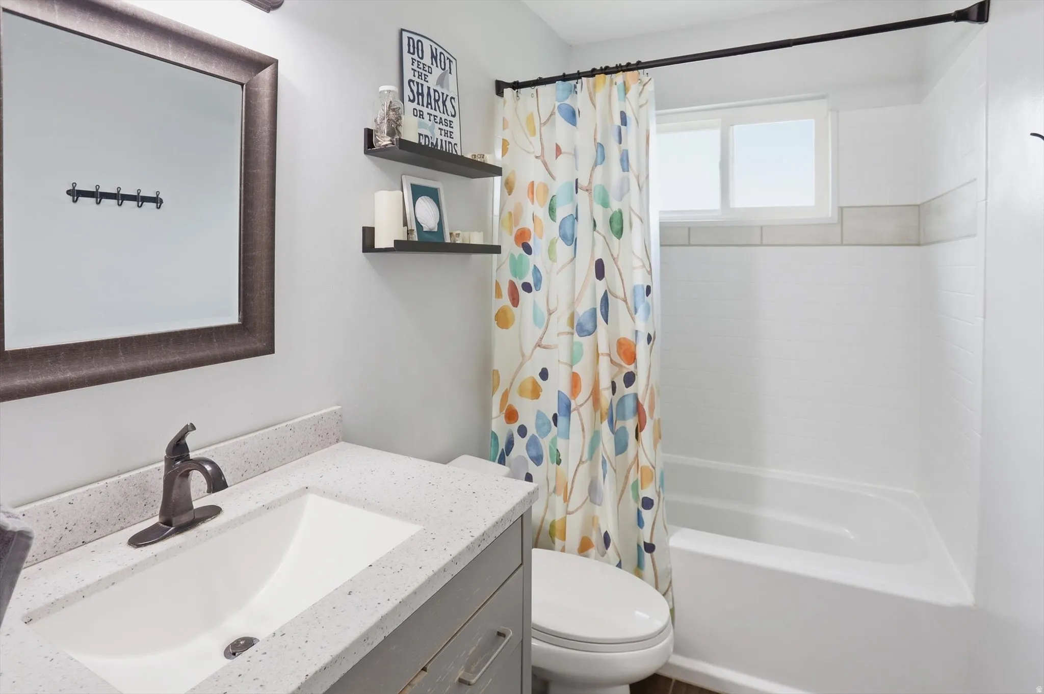 Bathroom featuring vanity and shower / tub combo with curtain