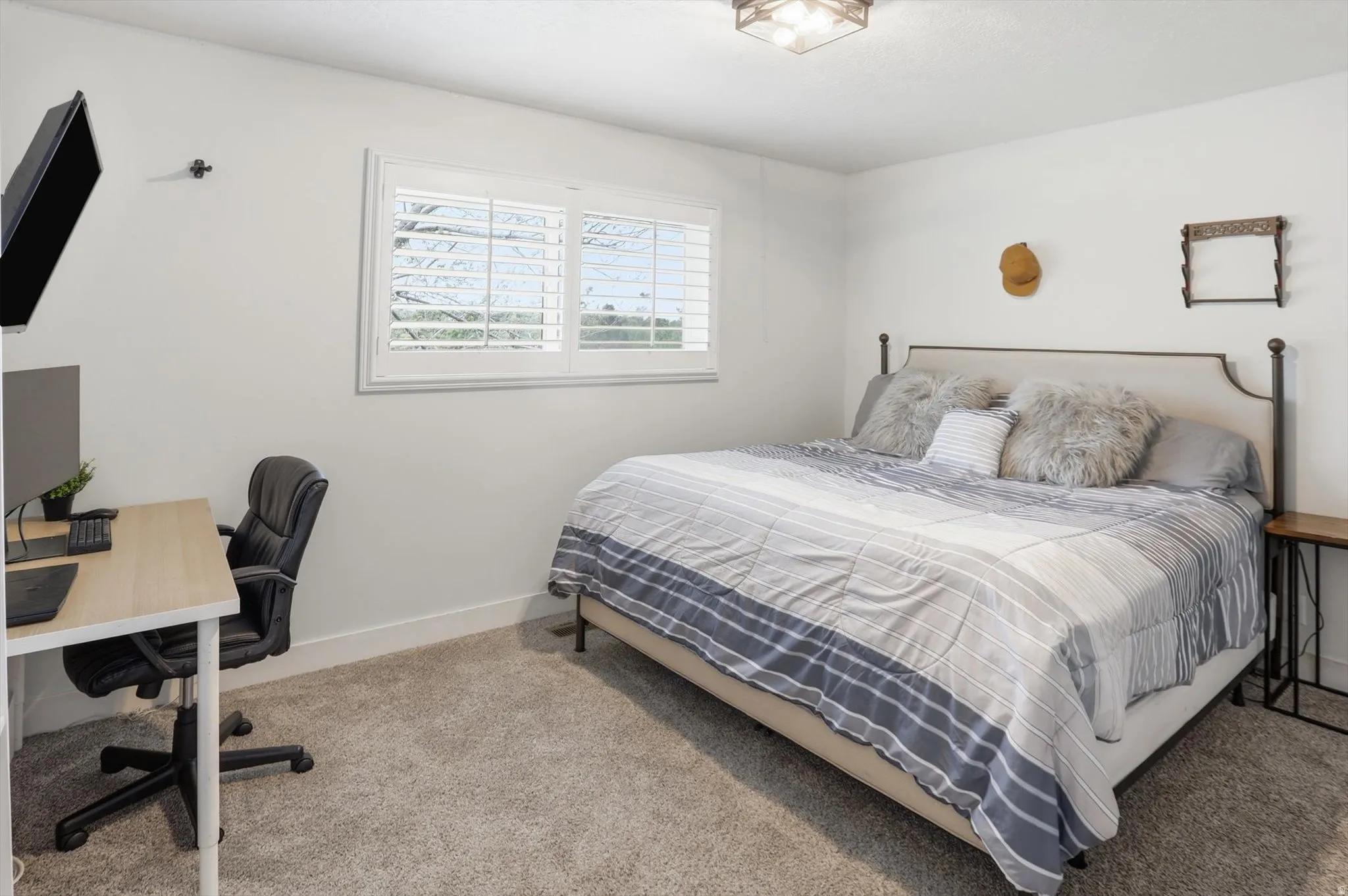 Bedroom featuring a desk and carpet flooring