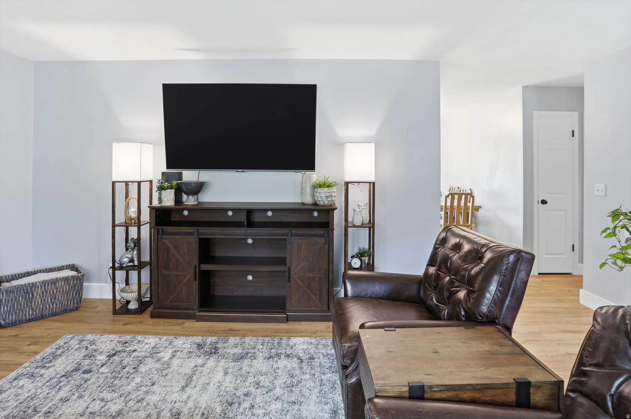 Living room featuring light wood-style flooring and baseboards