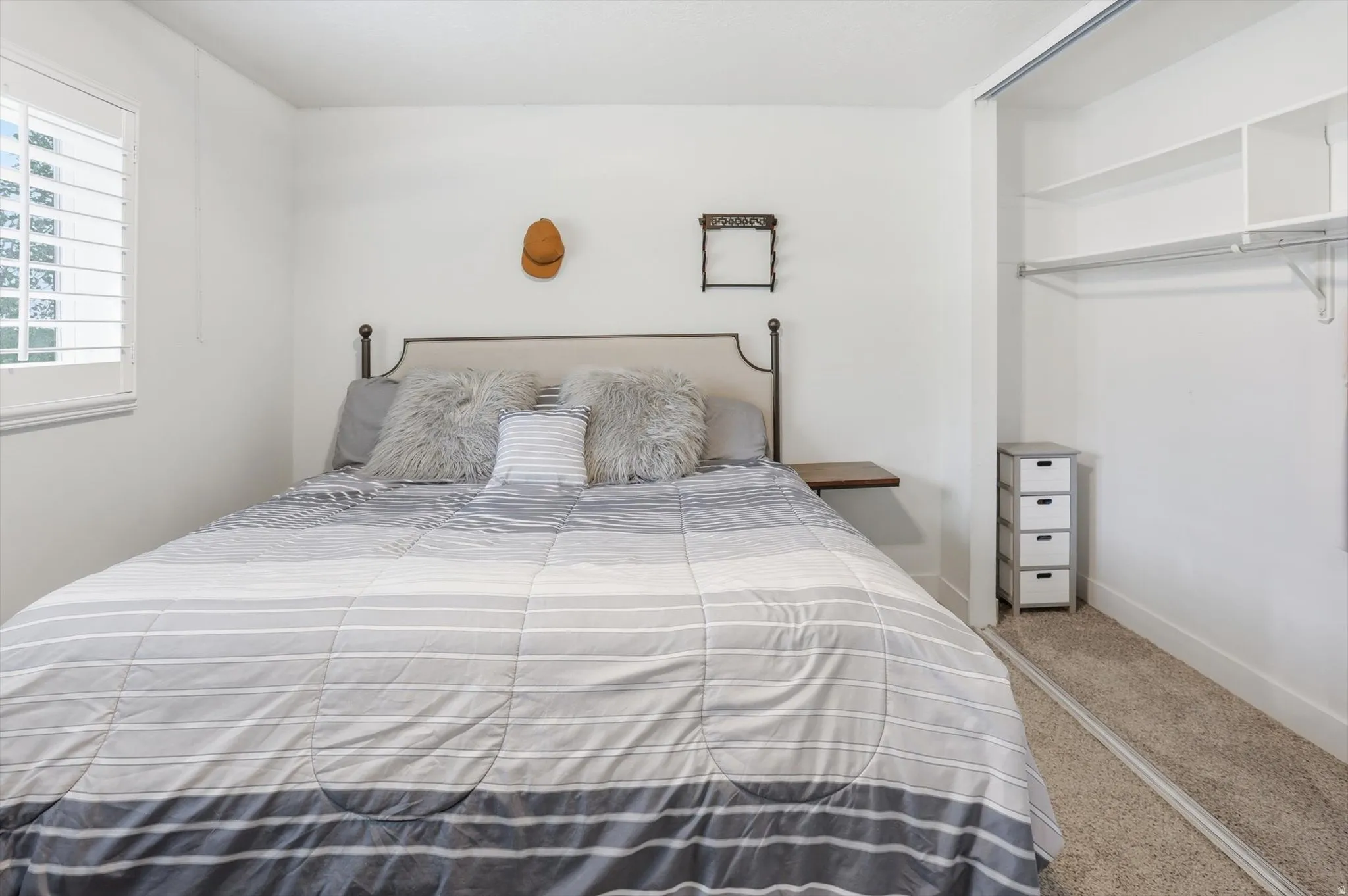 Bedroom with carpet flooring and baseboards