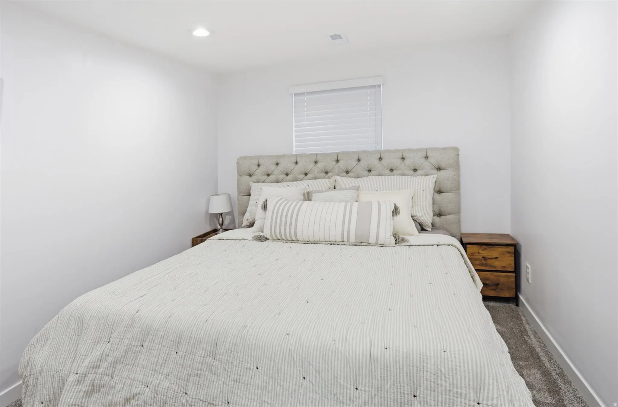 Carpeted bedroom with baseboards and recessed lighting