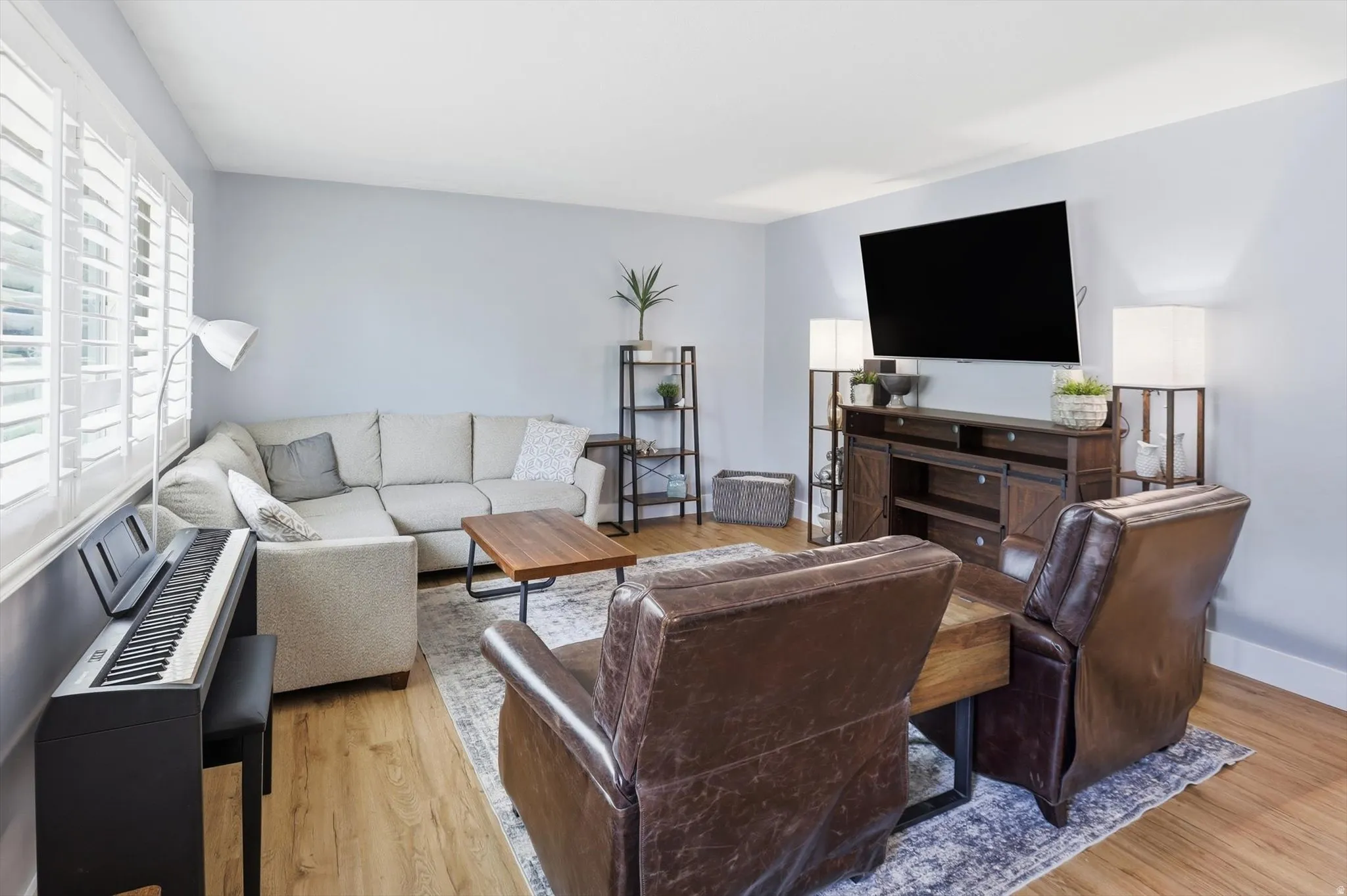 Living room with light wood-style flooring and baseboards