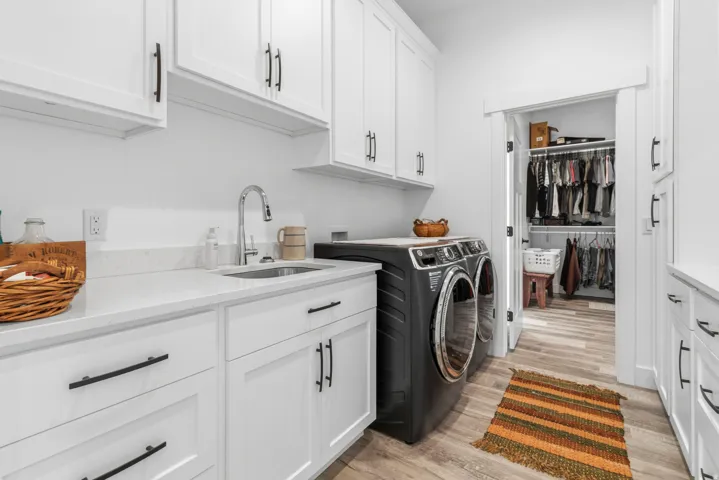 Laundry area featuring cabinet space, light wood-style floors, and washer and dryer