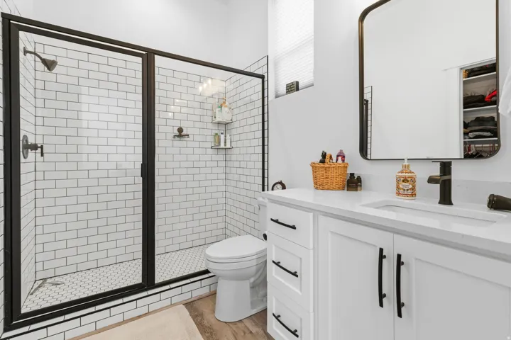 Bathroom with vanity, a stall shower, and light wood finished floors