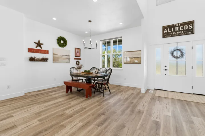 Dining space with light wood-type flooring and suspended lighting