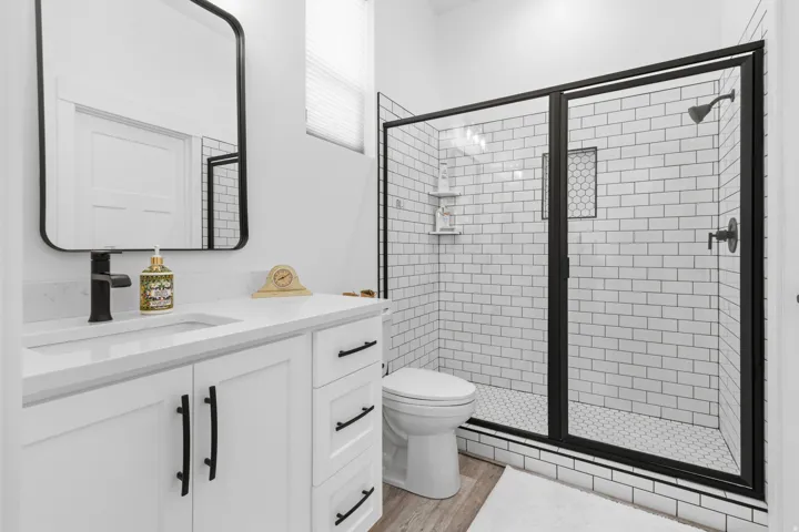 Bathroom featuring vanity, a stall shower, and light wood finished floors