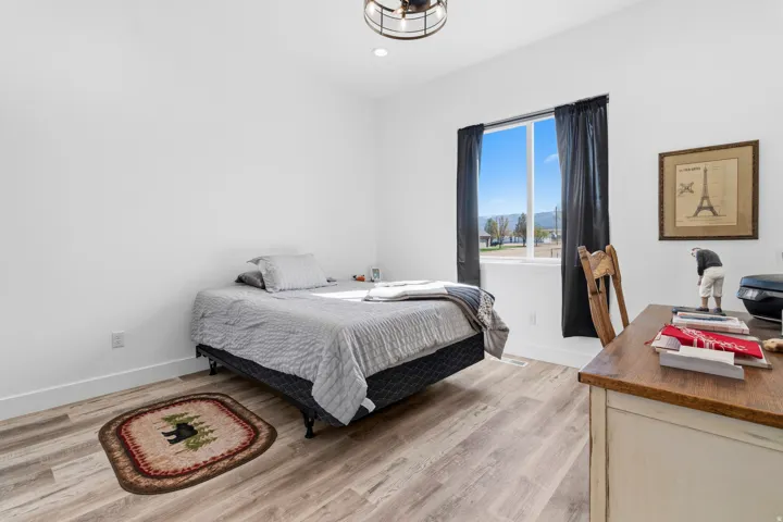 Bedroom featuring light wood finished floors, a desk, and recessed lighting