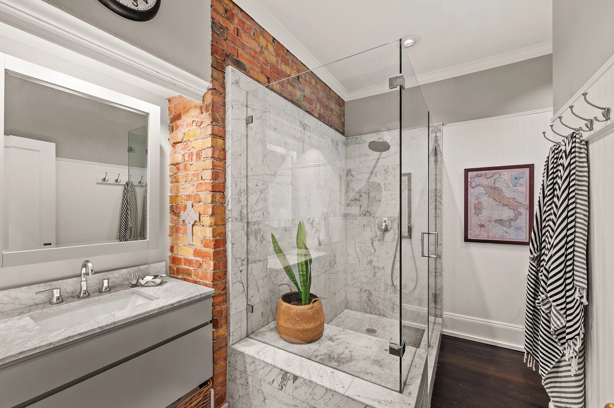 Bathroom with crown molding, a marble finish shower, vanity, and dark wood finished floors