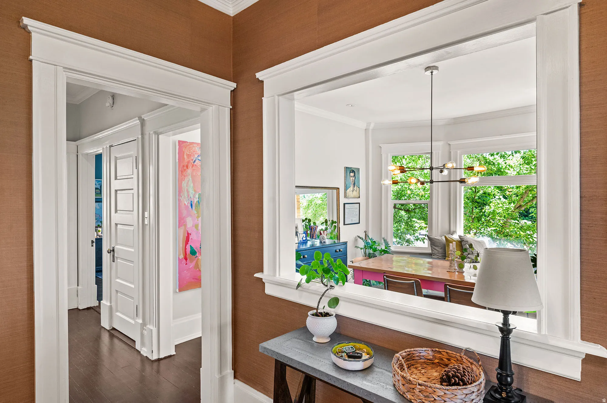 Hallway featuring ornamental molding, dark wood finished floors, and a chandelier