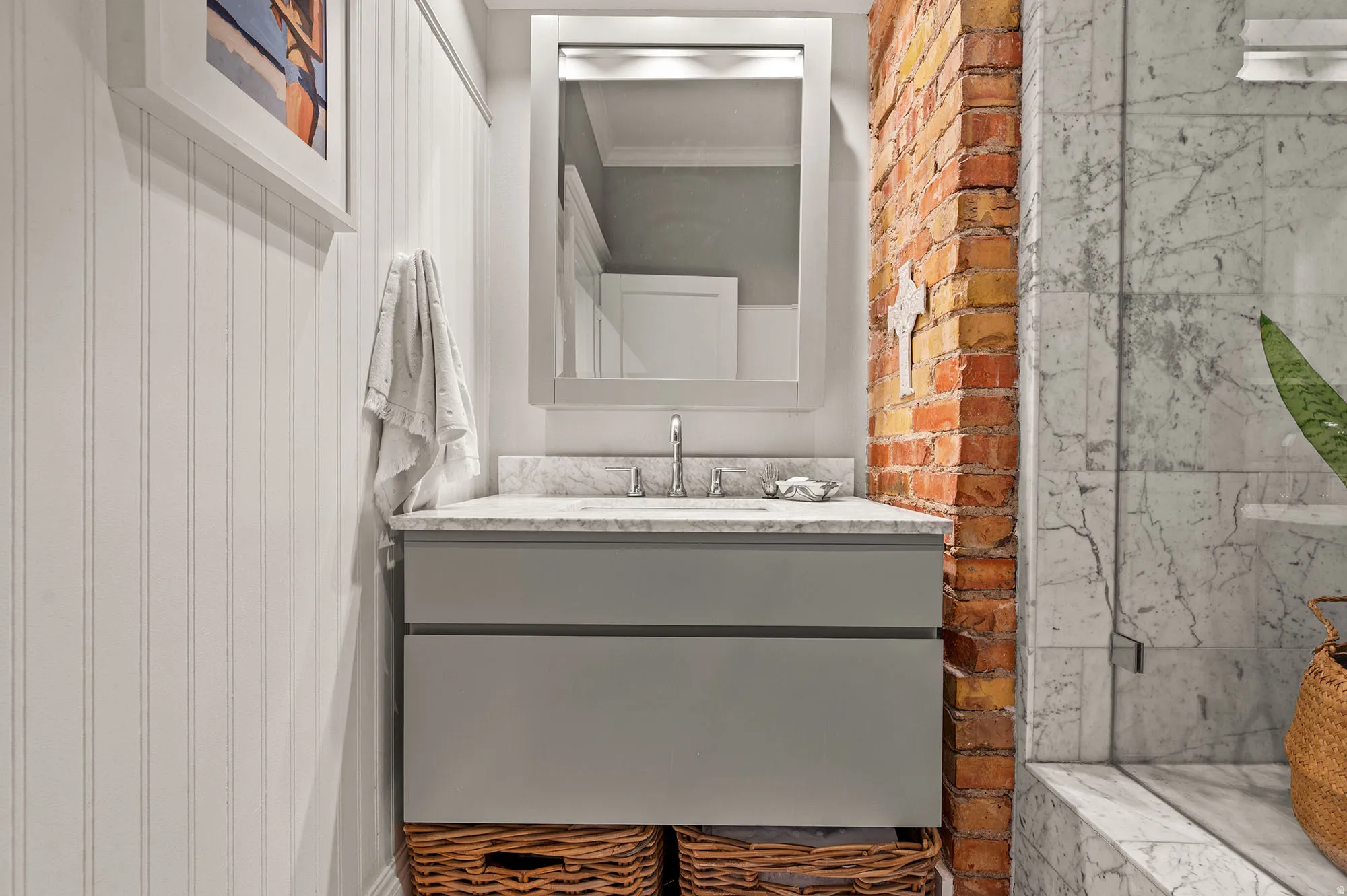 Bathroom featuring ornamental molding and vanity