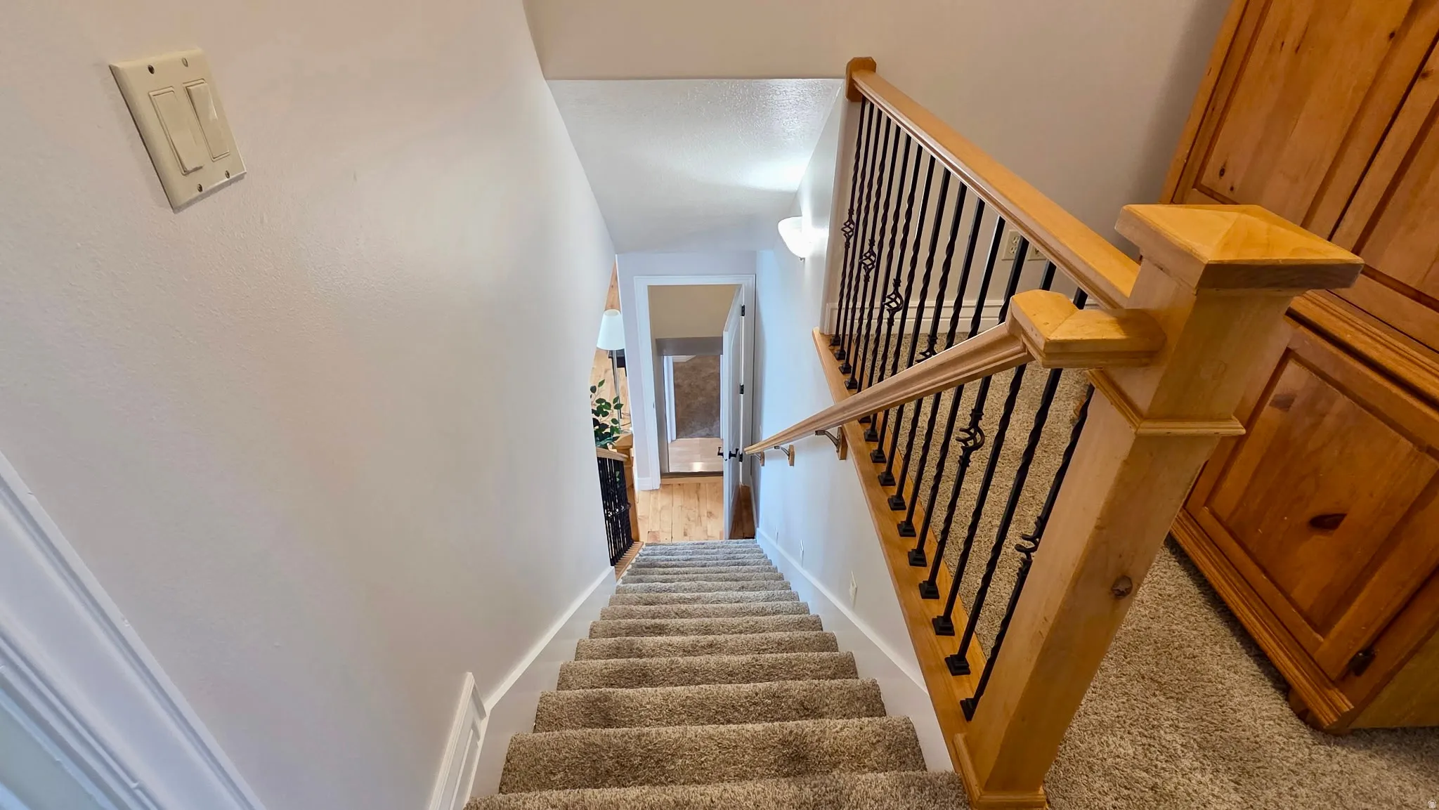 Stairs featuring baseboards and carpet flooring
